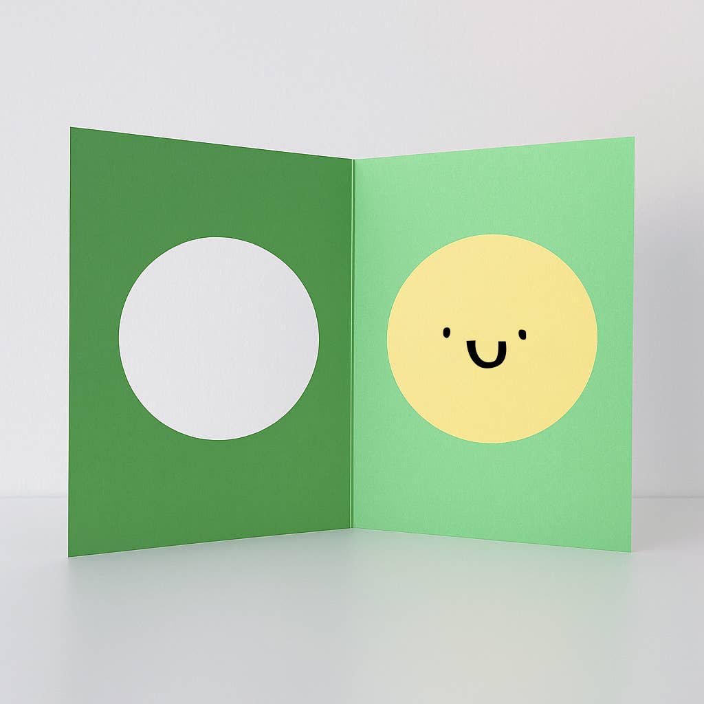 Green card with a white circle on one side and a yellow circle with a smiley face on the other, on a light gray background.