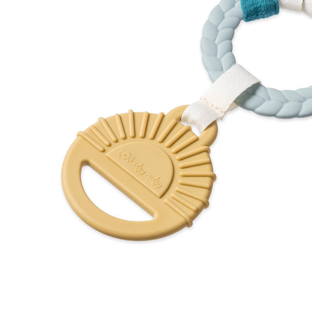 Teething ring with a beige disc and braided blue and white handle on a white background