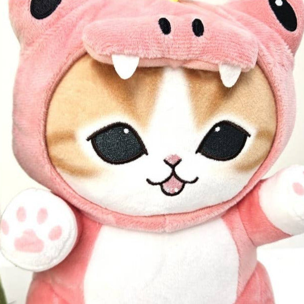 Plush toy cat in a pink dragon costume with a white background