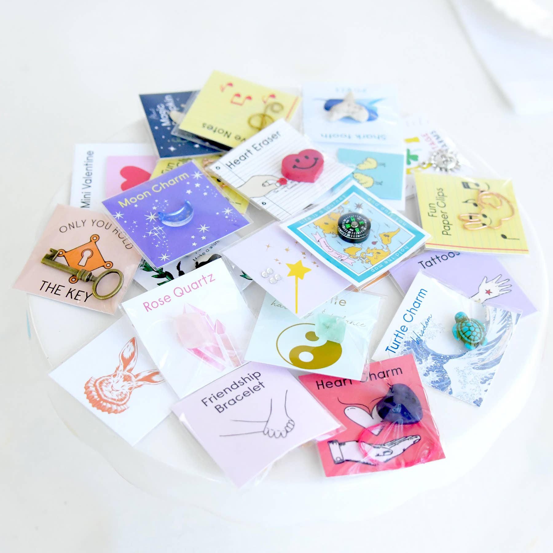 Collection of small cards with various designs and text on a white surface