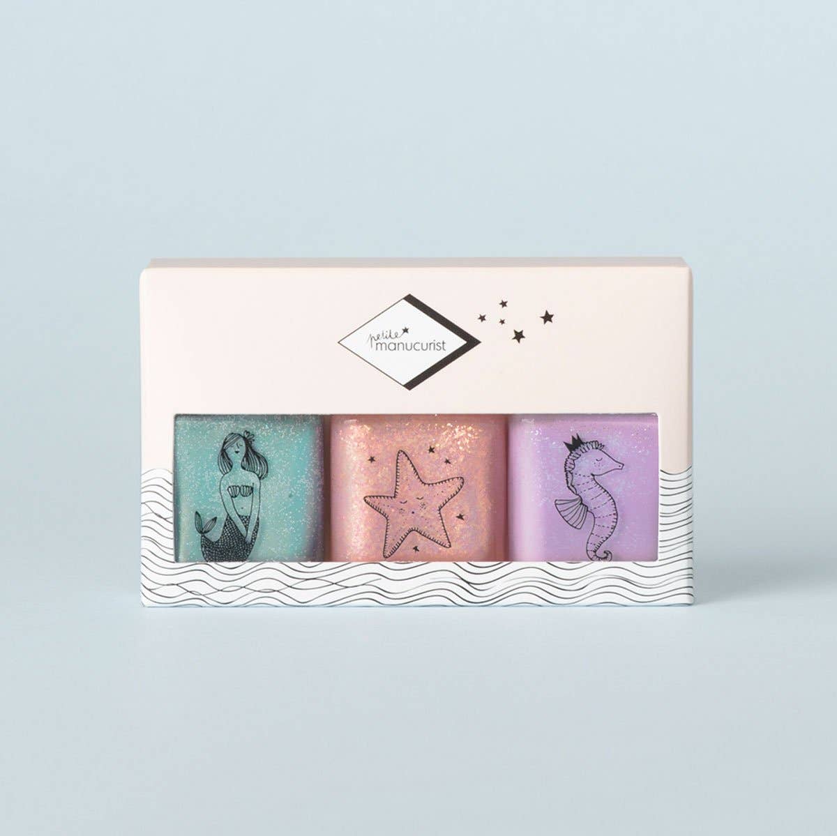 Set of three soaps with mermaid, star, and seahorse designs in a decorative box on a light blue background.