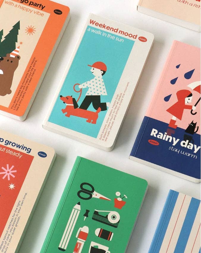 Collection of colorful notebooks with illustrated covers on a white background
