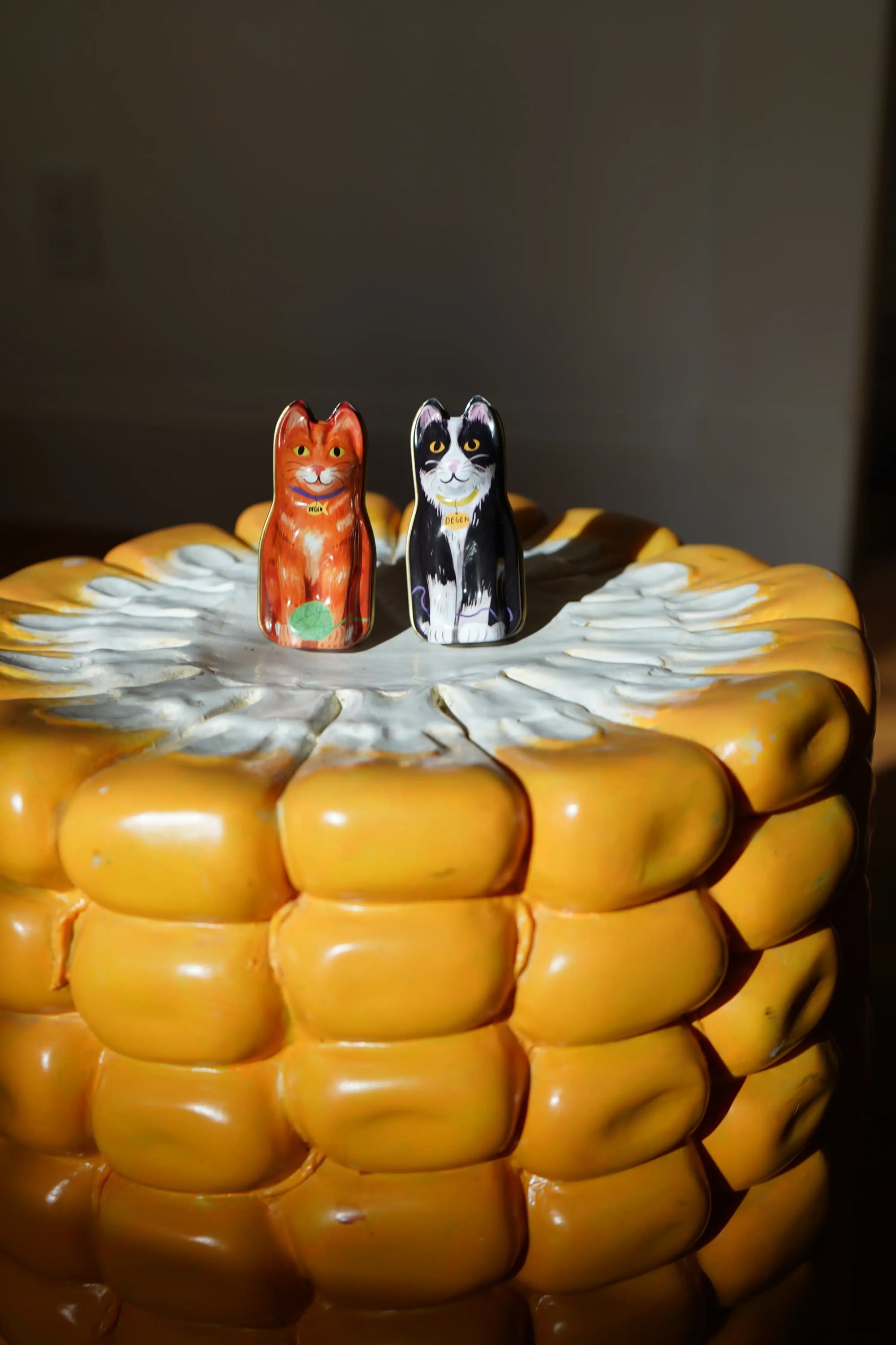 Corn on the cob with cat-shaped salt and containers on top