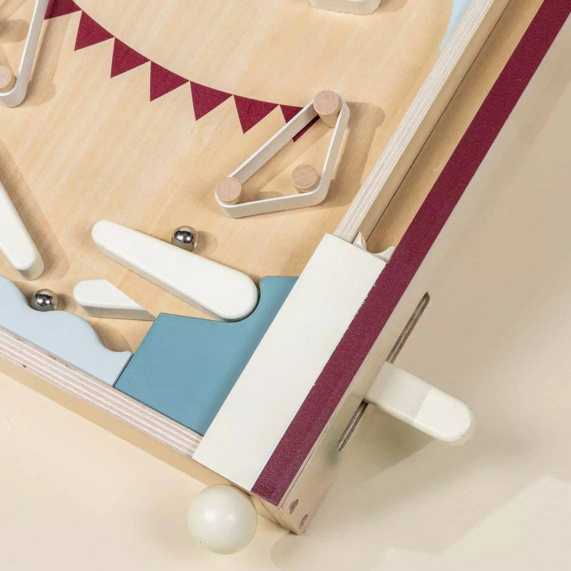 Wooden toy with colorful pegs on a beige background