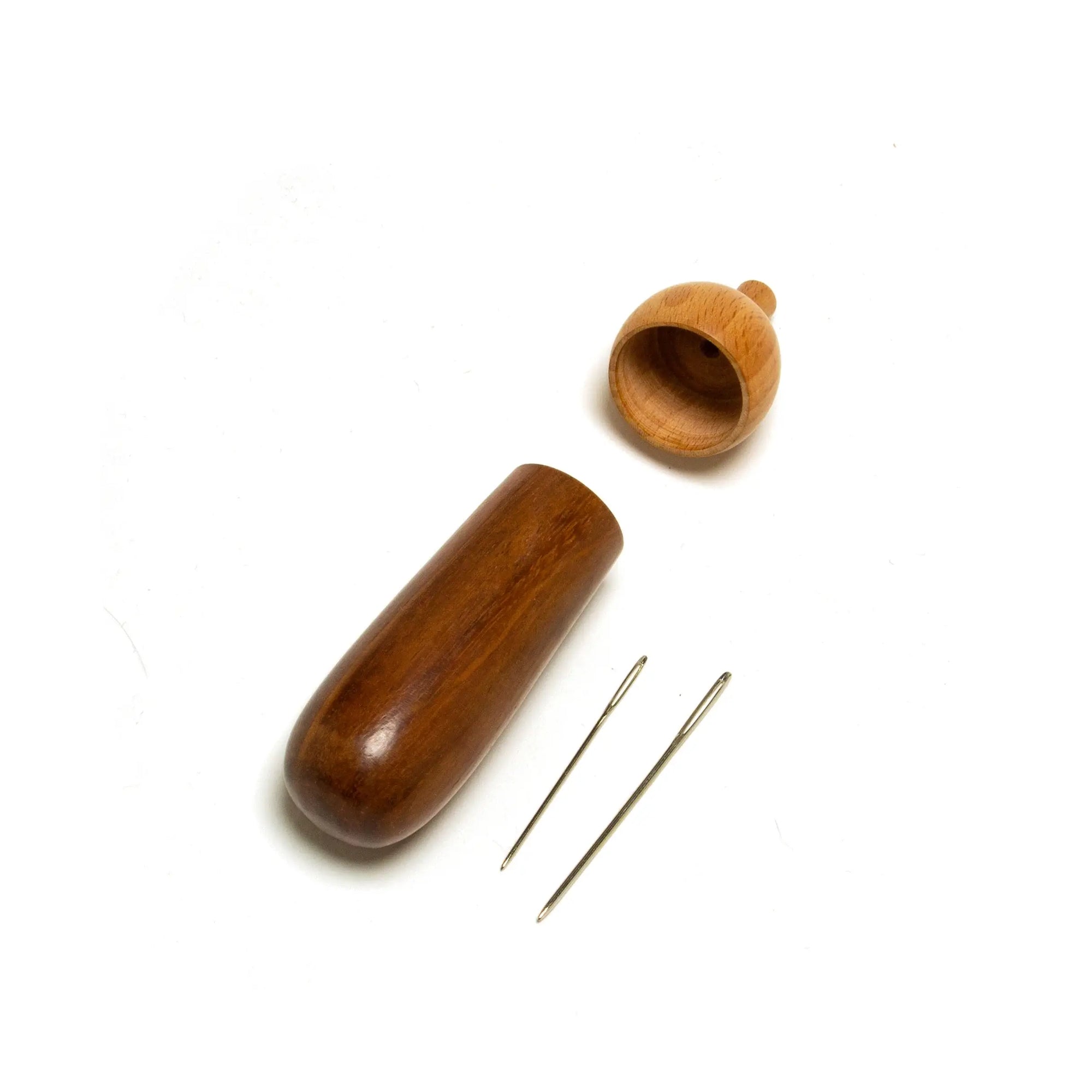 Wooden acupuncture tool set with needles on a white background