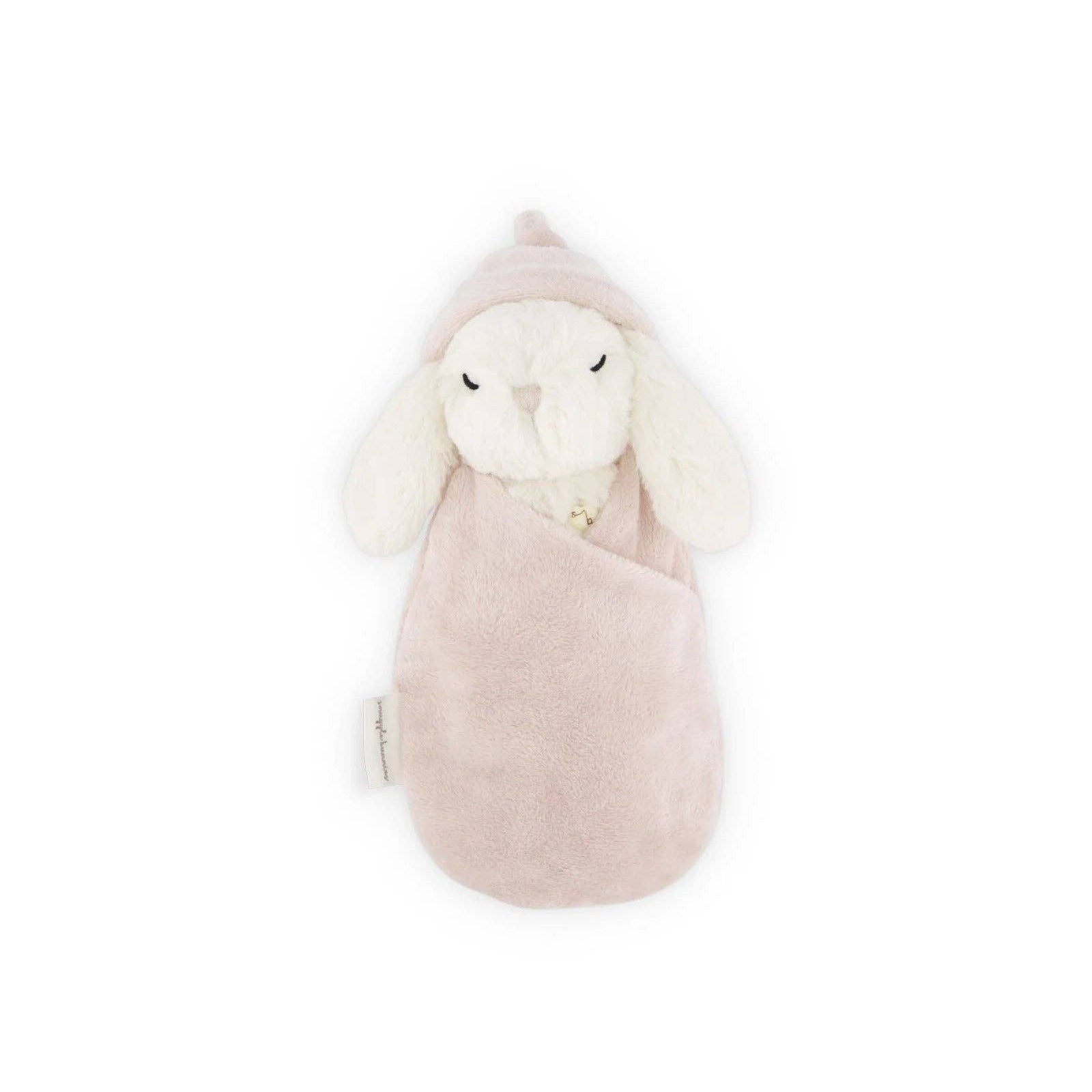 Plush toy rabbit in a pink outfit on a white background