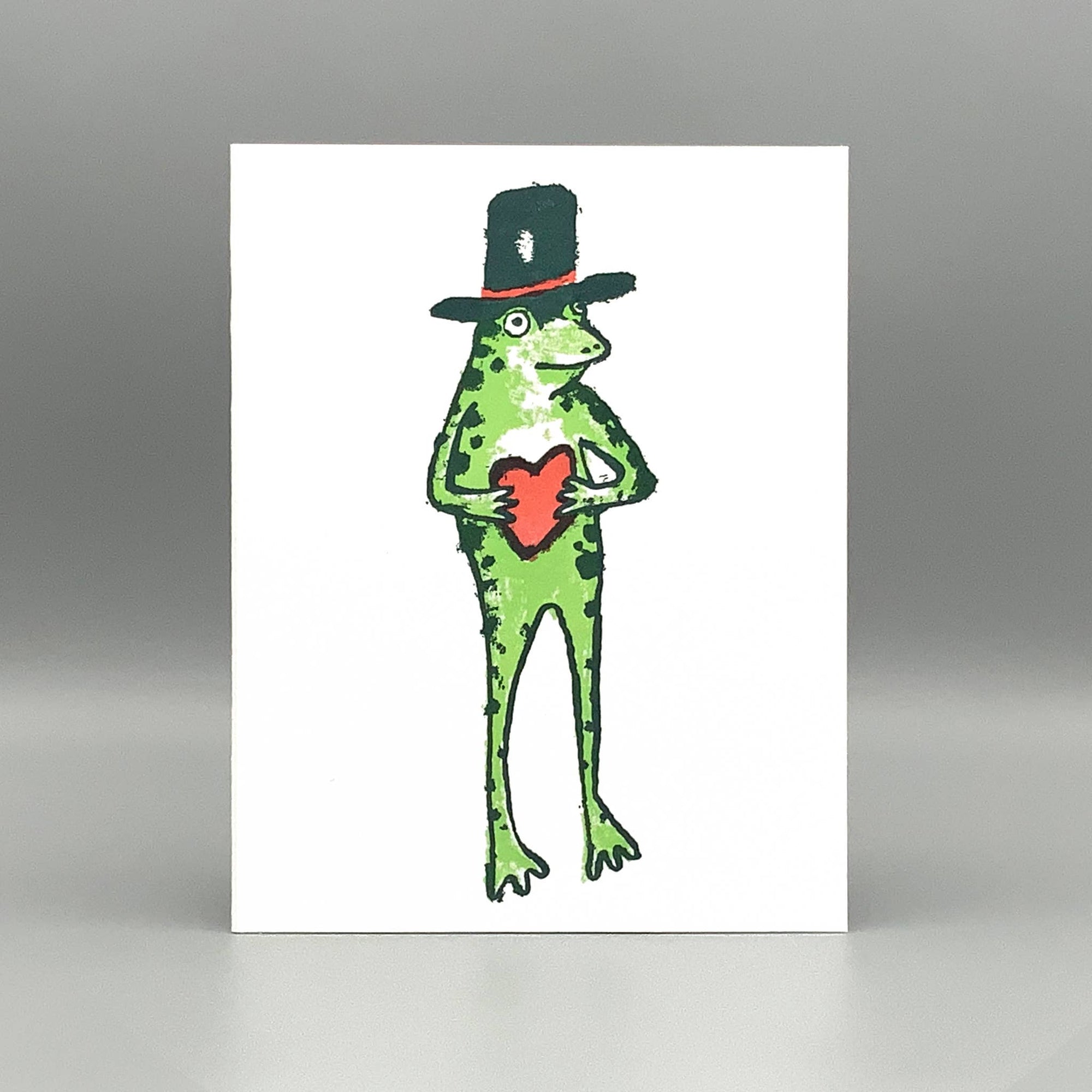 Illustration of a frog wearing a top hat and holding a red heart on a white background