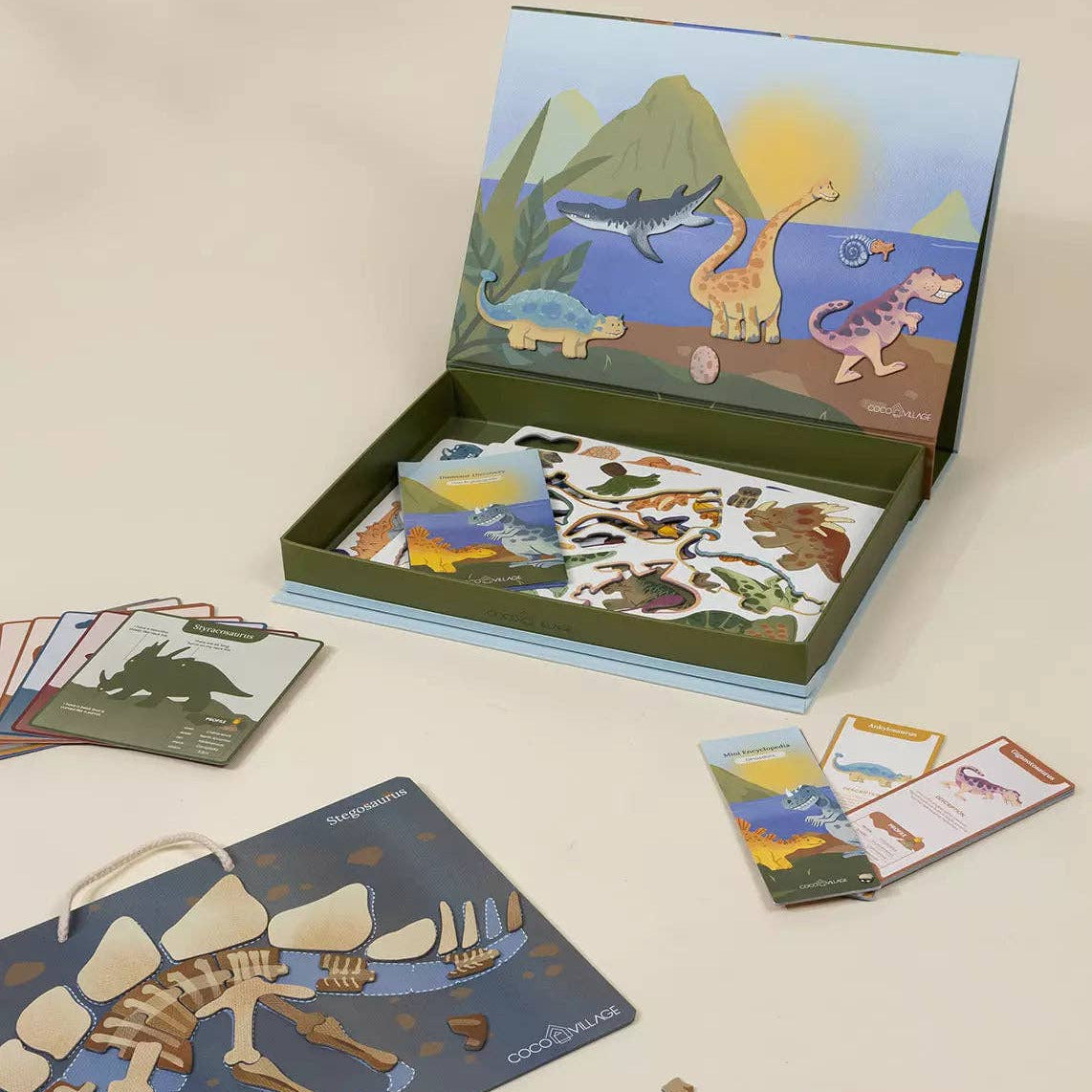 Children's educational puzzle set with dinosaur-themed cards and box on a beige background