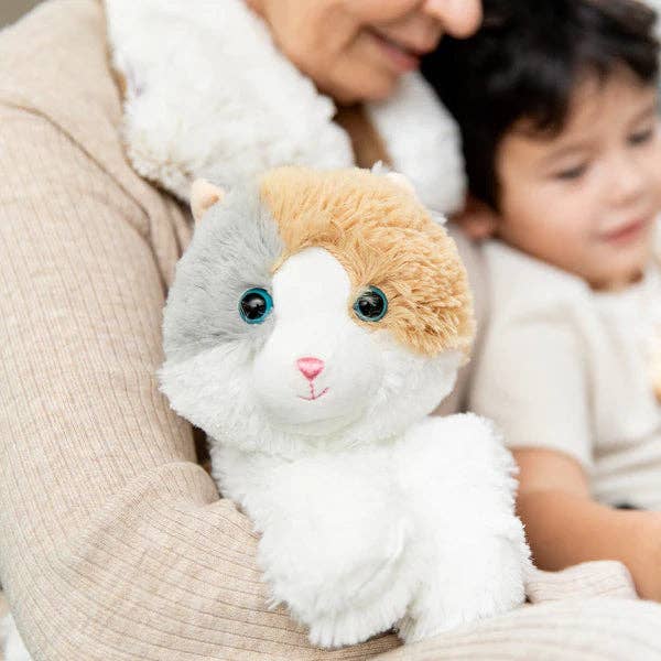 Person holding a plush toy cat with a child in the background