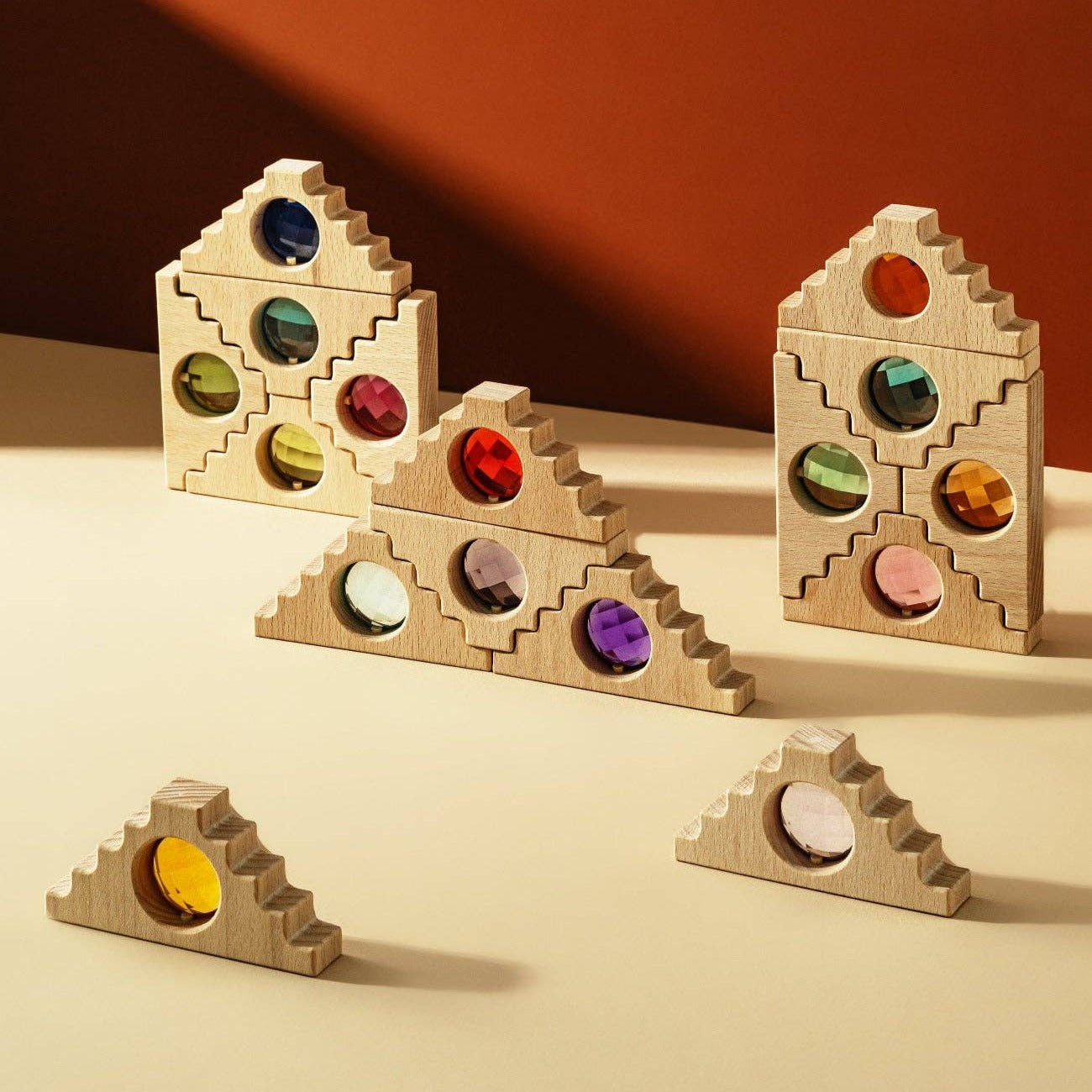 Wooden blocks with colorful beads on a beige surface and brown background