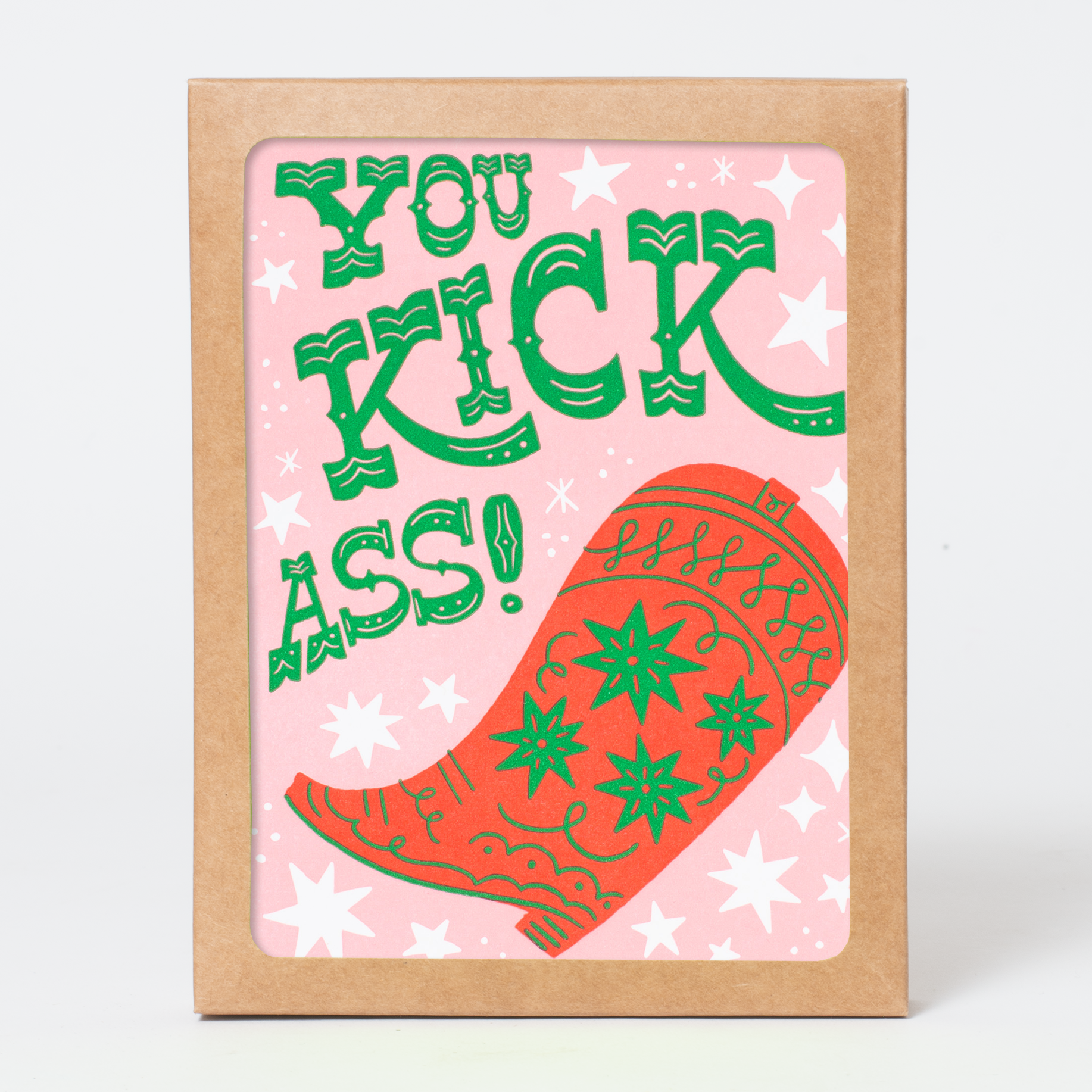 Card with green text 'You Kick Ass!' and a red boot on a pink background with white stars, framed in brown.