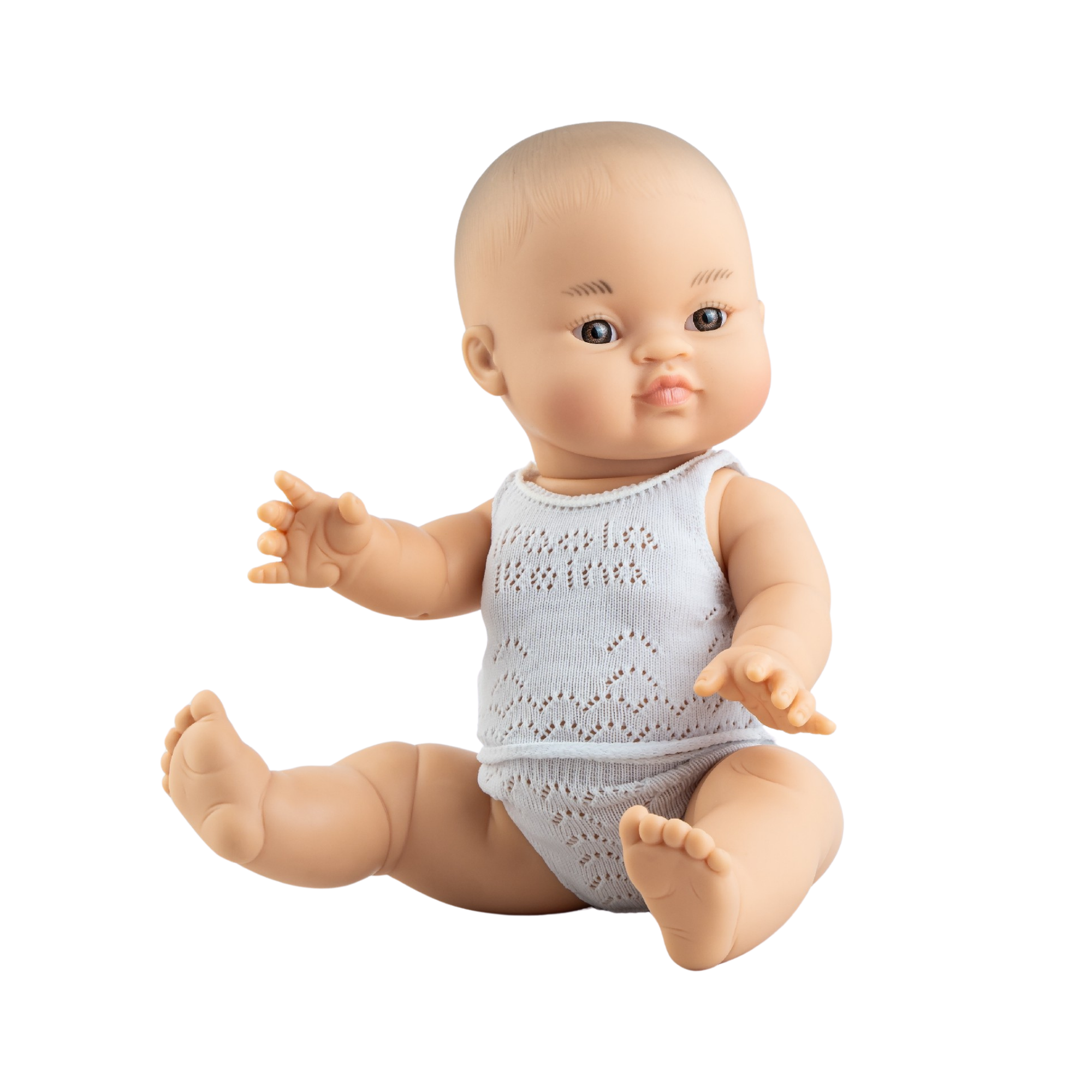 Baby doll wearing a light blue knitted outfit on a white background