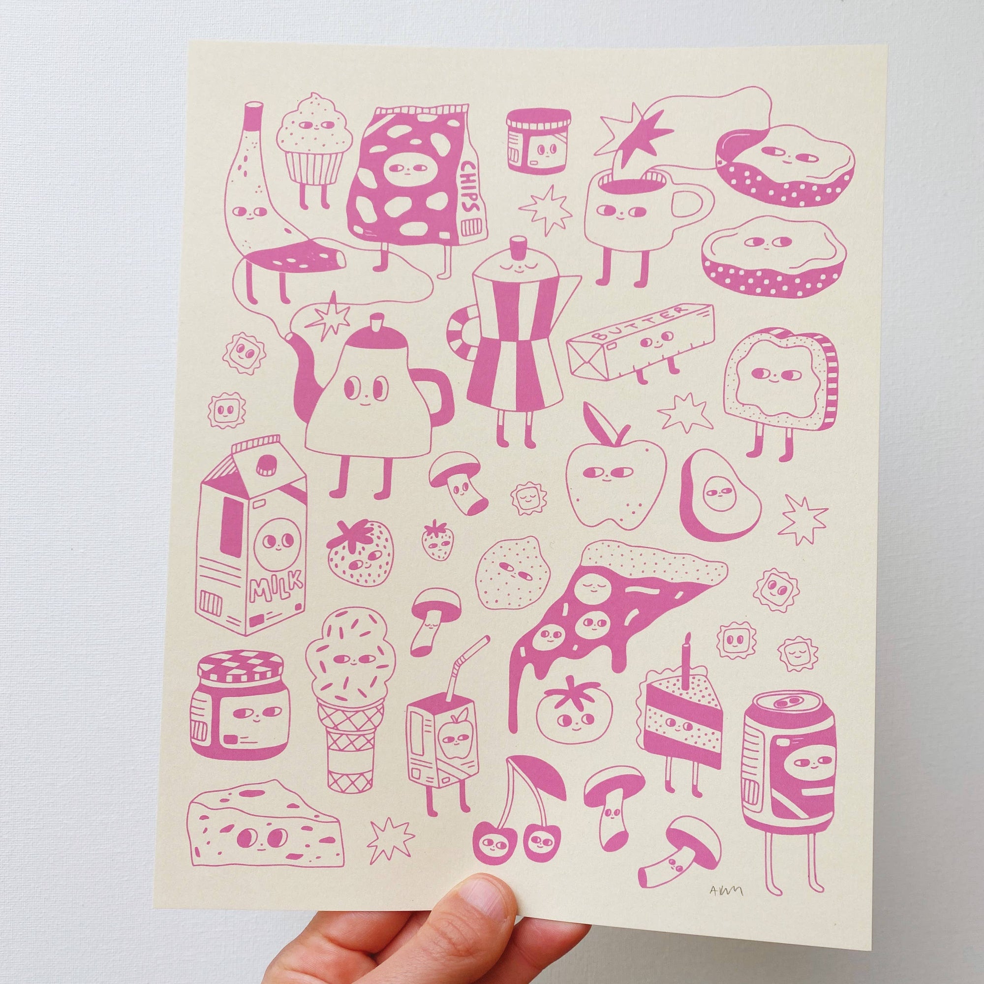Hand holding a pink food and drink illustration sheet against a white background