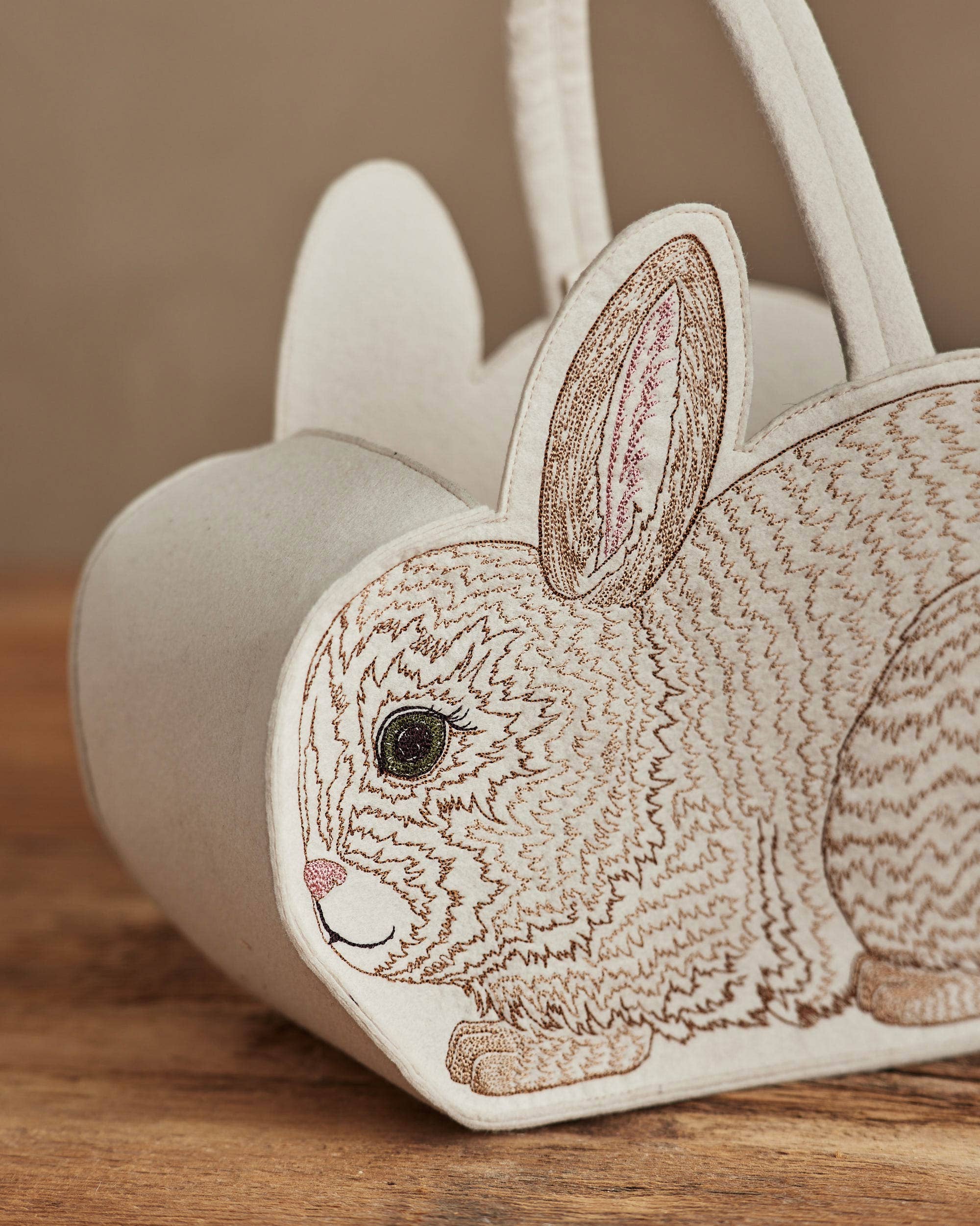 Decorative bunny-shaped container on a wooden surface