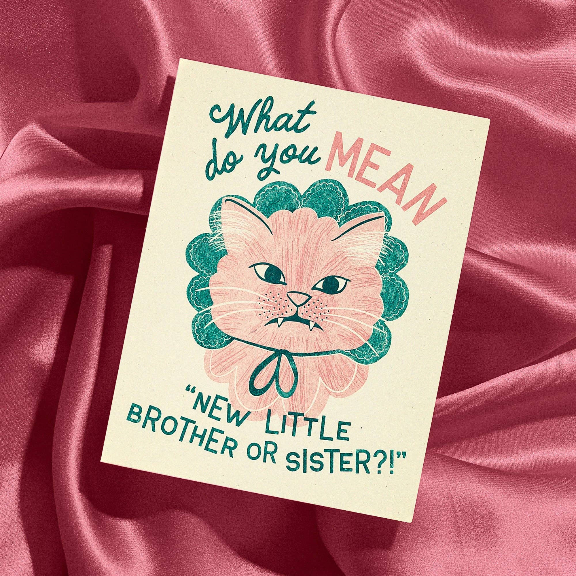 Card with a cat illustration and text on a pink satin background