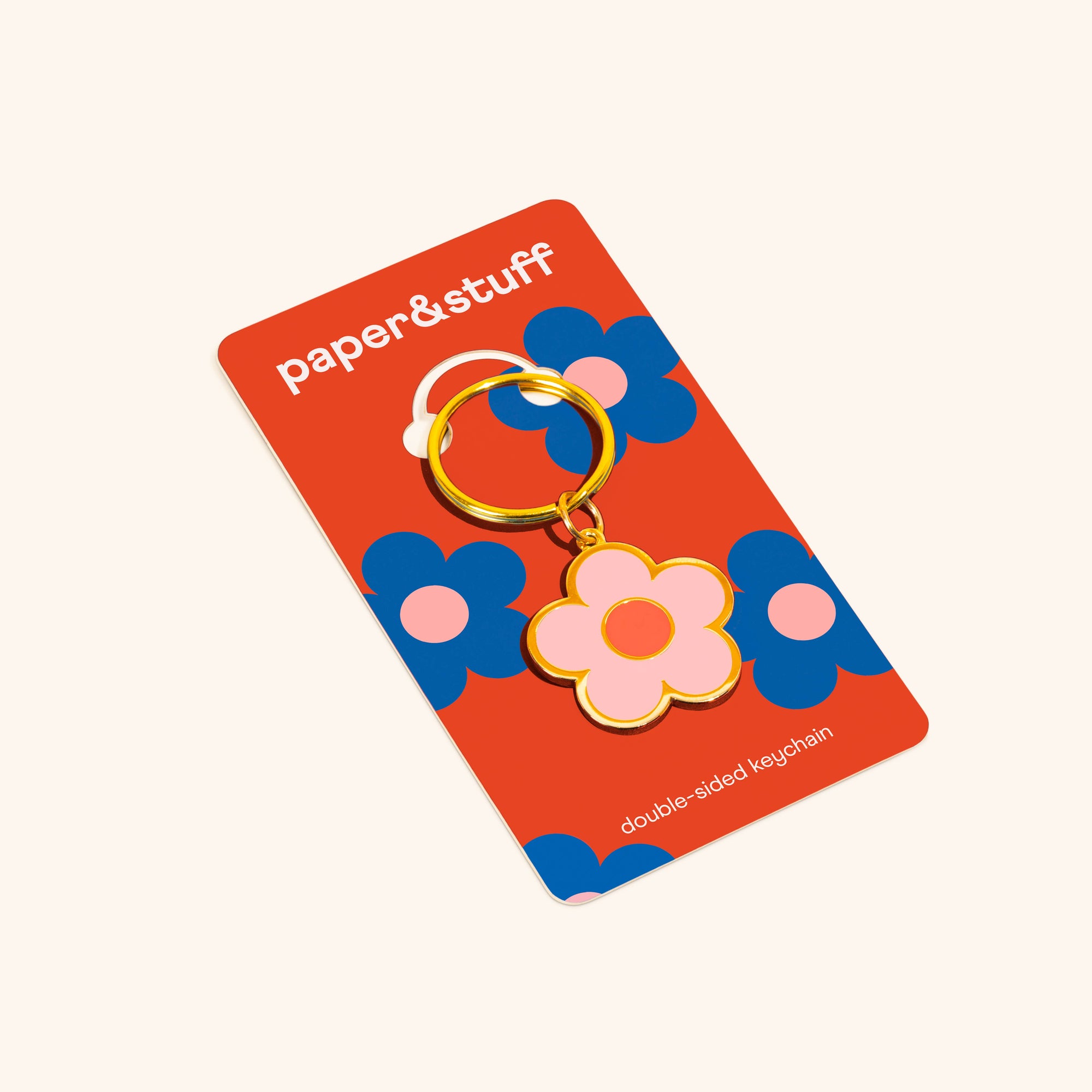 Floral keychain on a 'paper&stuff' branded card with a white background