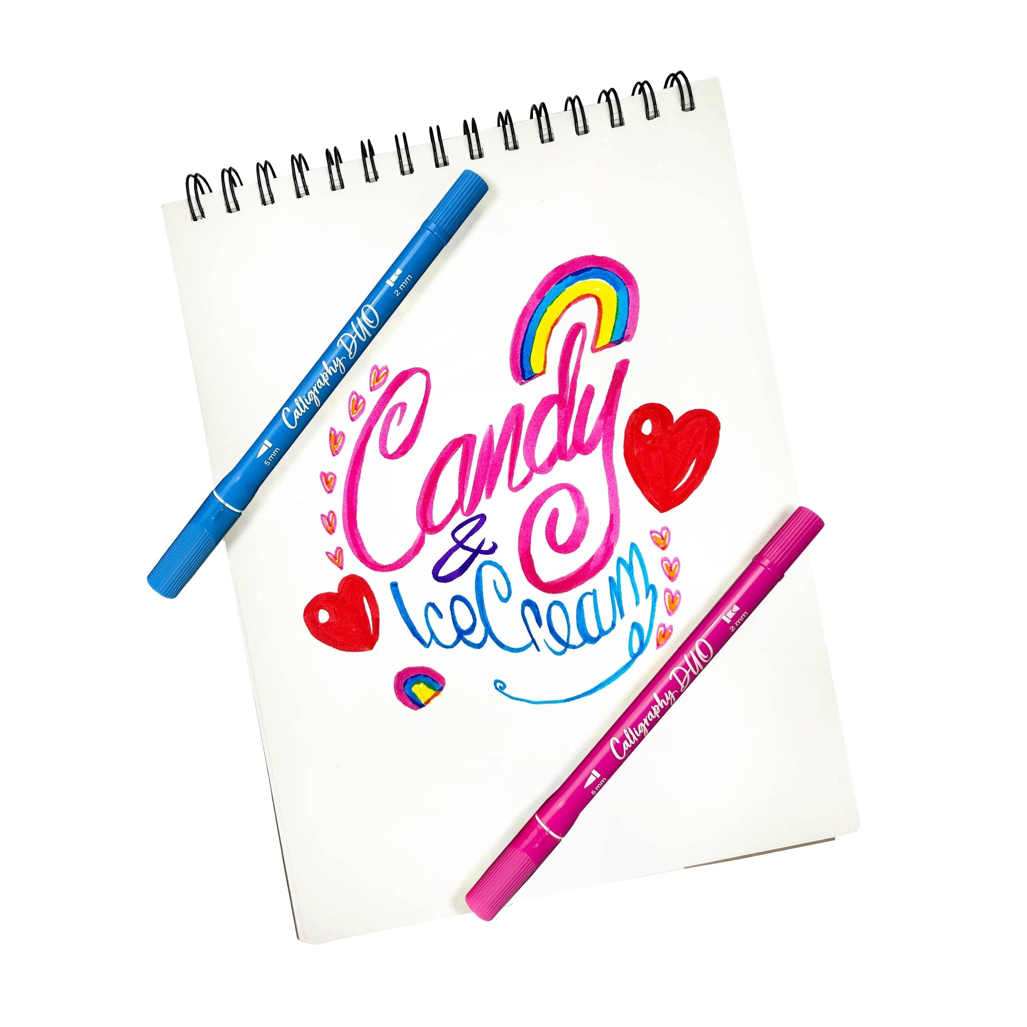 Notebook with colorful text and two pens on a white background