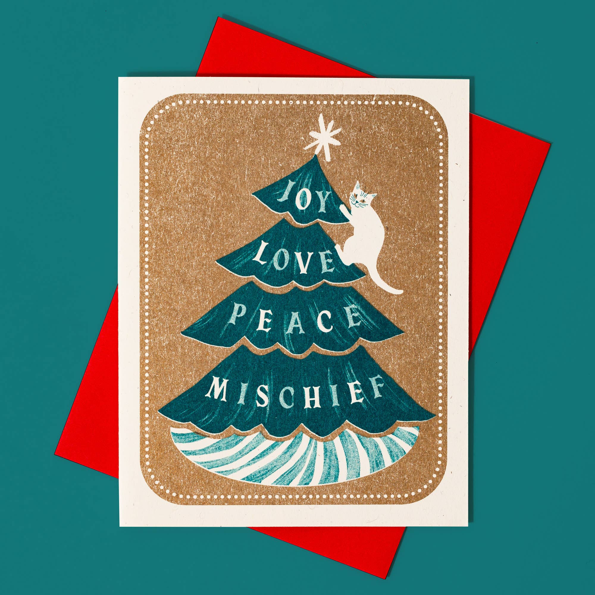 Greeting card with Christmas tree design and cat, on a red envelope against a teal background.