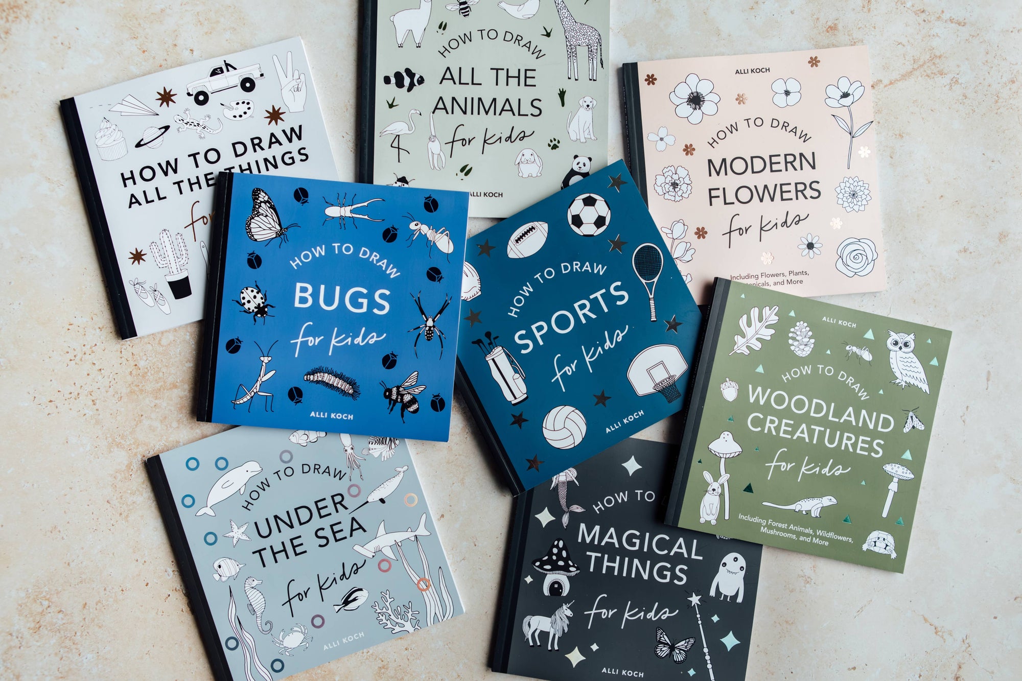 Collection of books on drawing various topics for kids on a light surface.