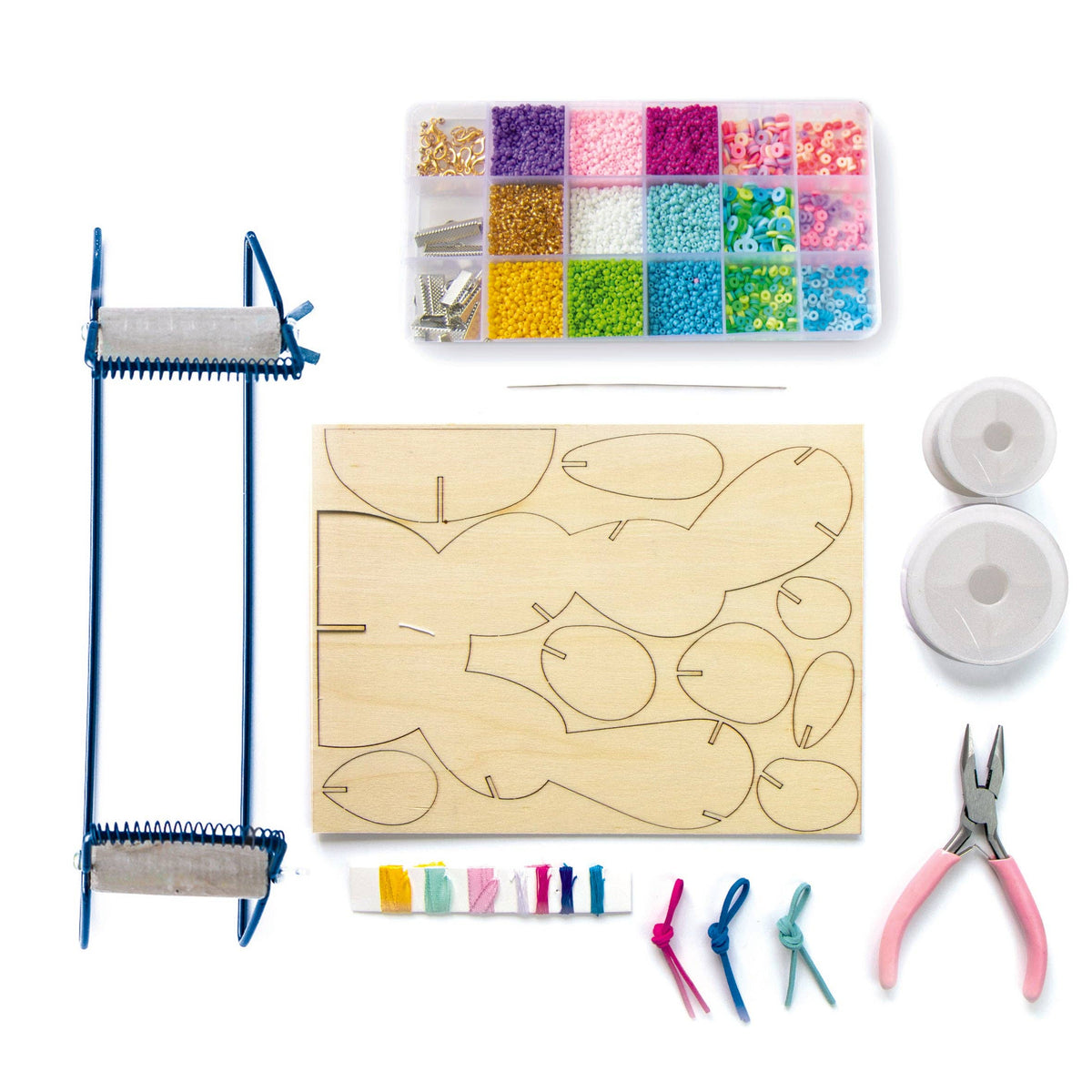 A bead embroidery kit laid out on a white background, including a wooden frame, a wooden template with stitched outlines, a clear plastic organizer filled with colorful beads, thread spools, pliers, and small pieces of thread.