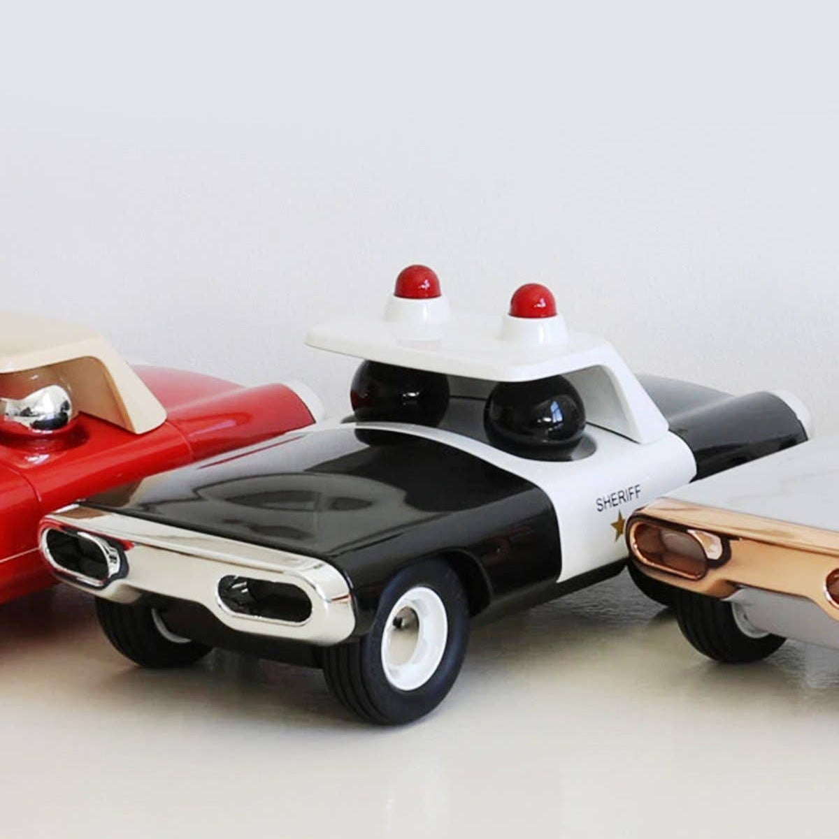 Toy police car with red lights on a white background