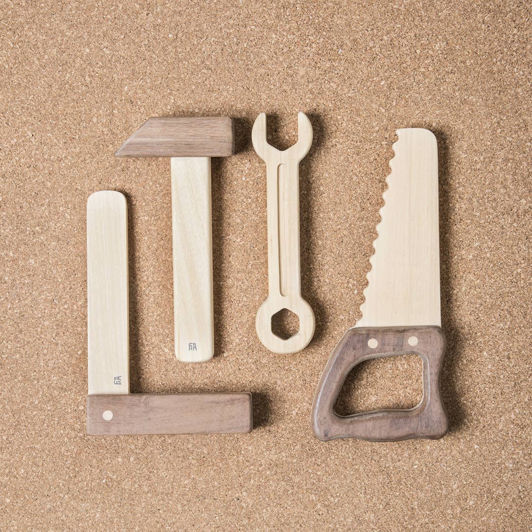 Set of wooden tools including a saw, wrench, and others on a brown background