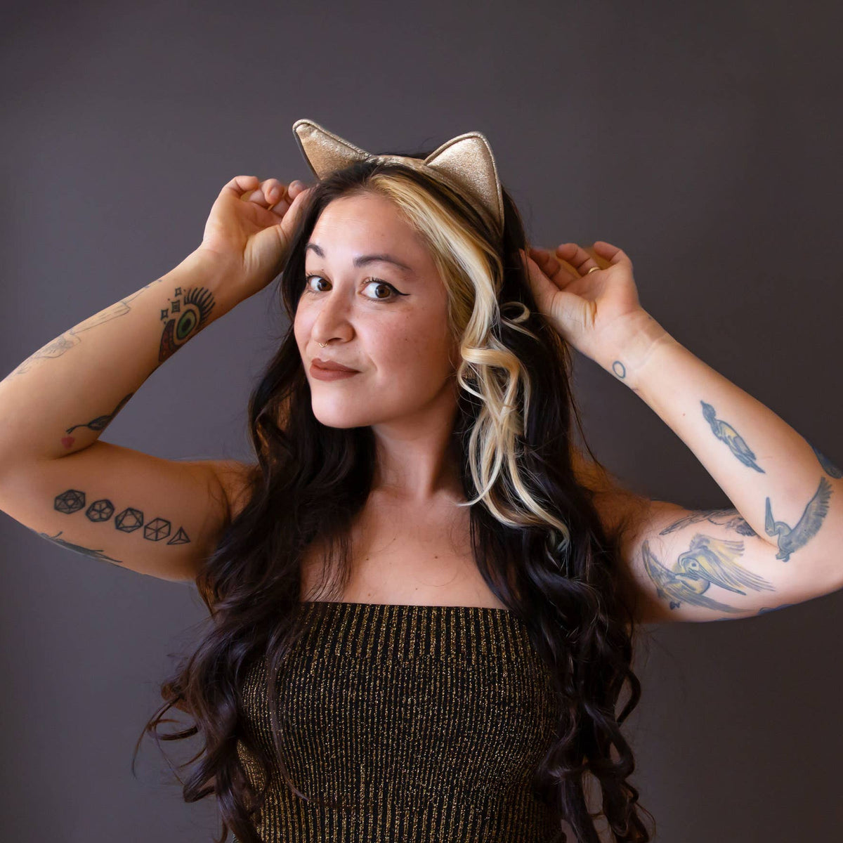 Woman wearing cat ears against a dark background