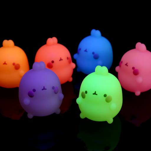 Colorful cartoon-like figures glowing in the dark on a black background