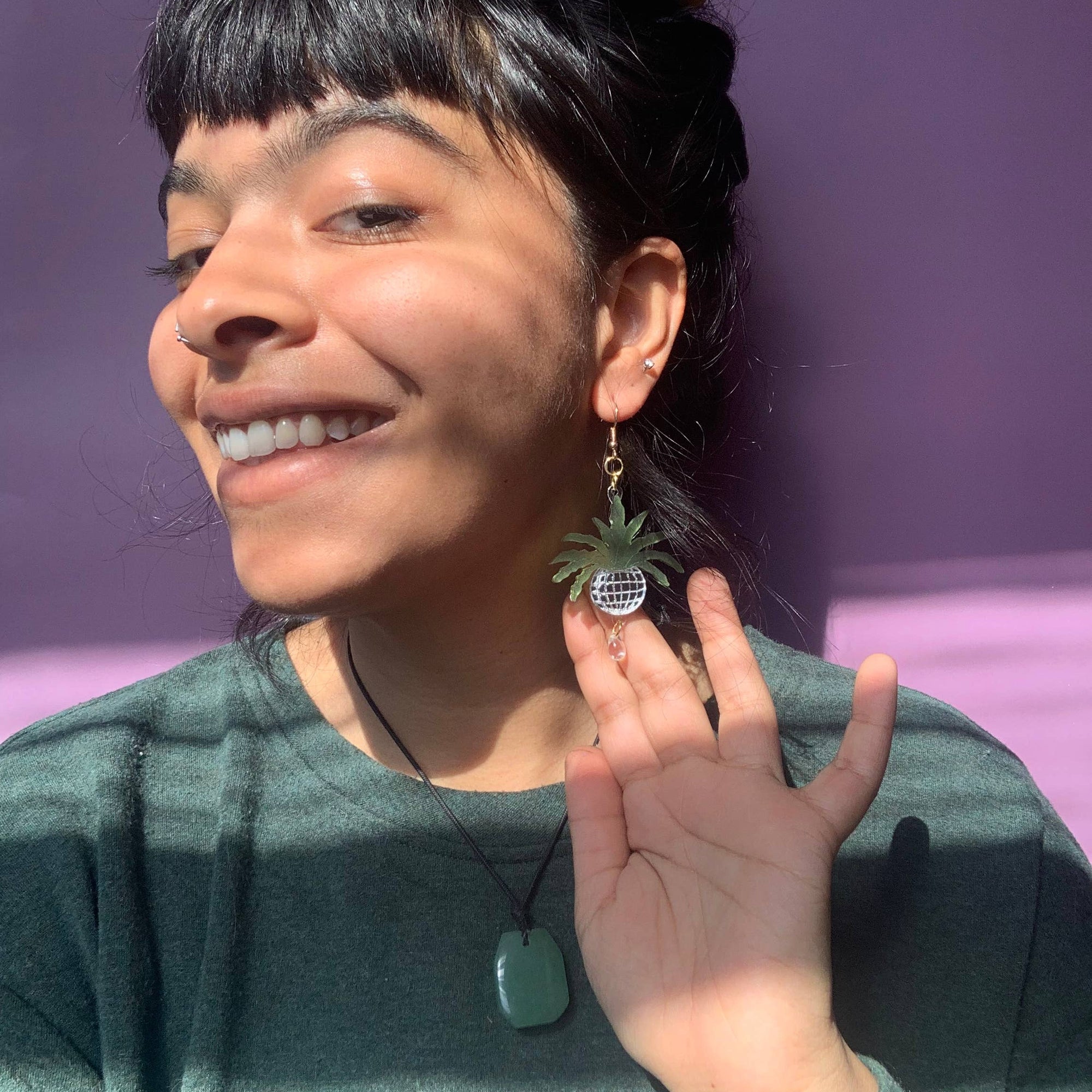 Person wearing a green shirt with a purple background