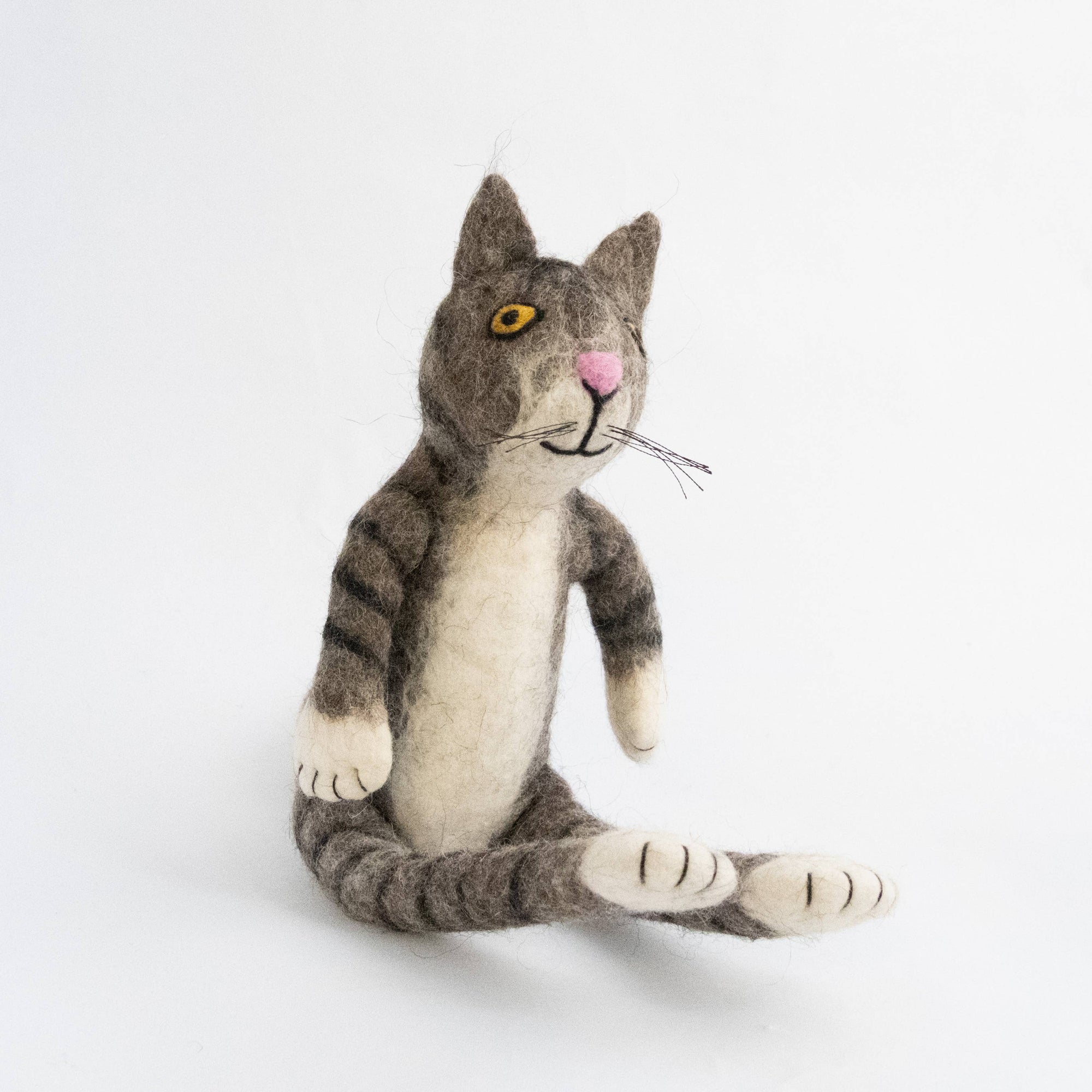 Stuffed toy cat with gray and white stripes on a white background