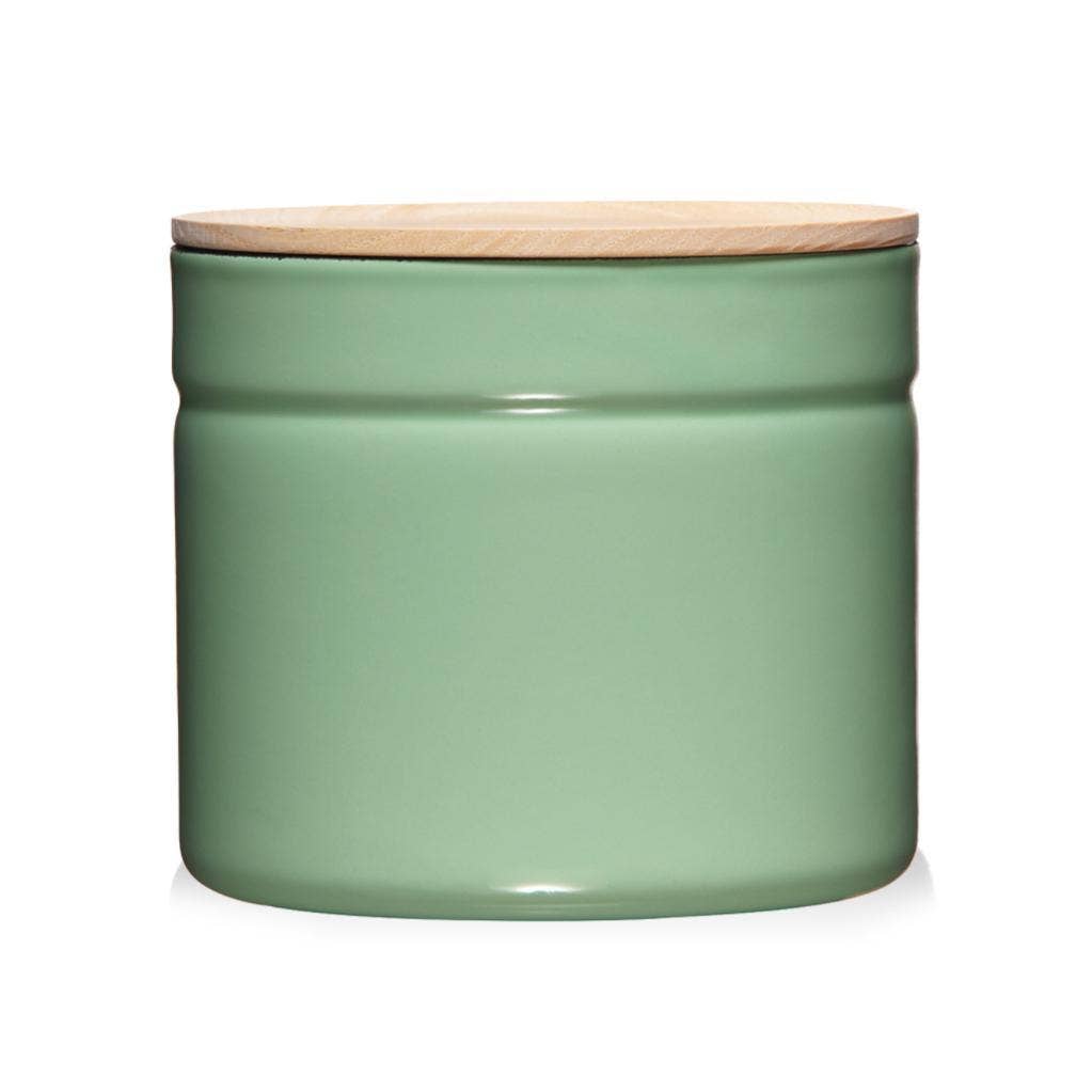 Green metal jar with a wooden lid on a white background