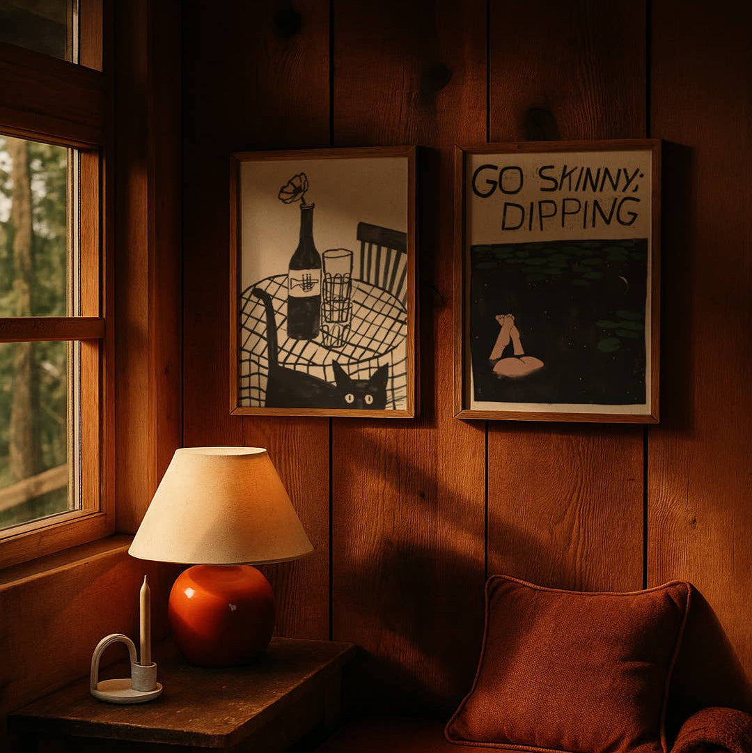 Cozy corner with a lamp, cushion, and framed pictures on wooden walls.