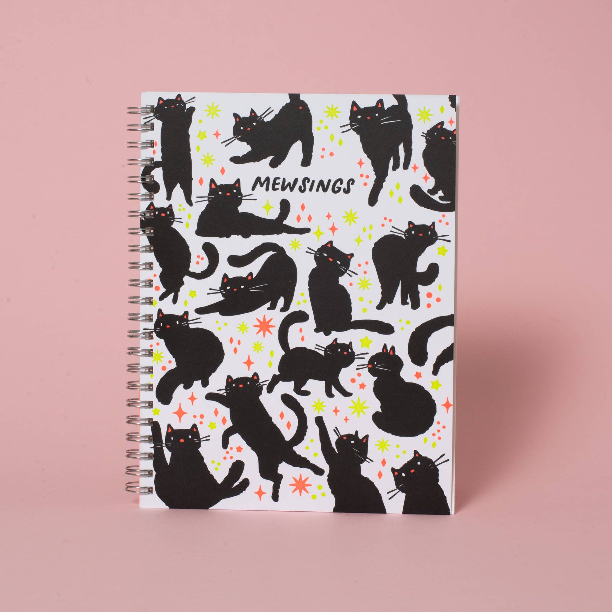 Notebook with black cat pattern on a pink background