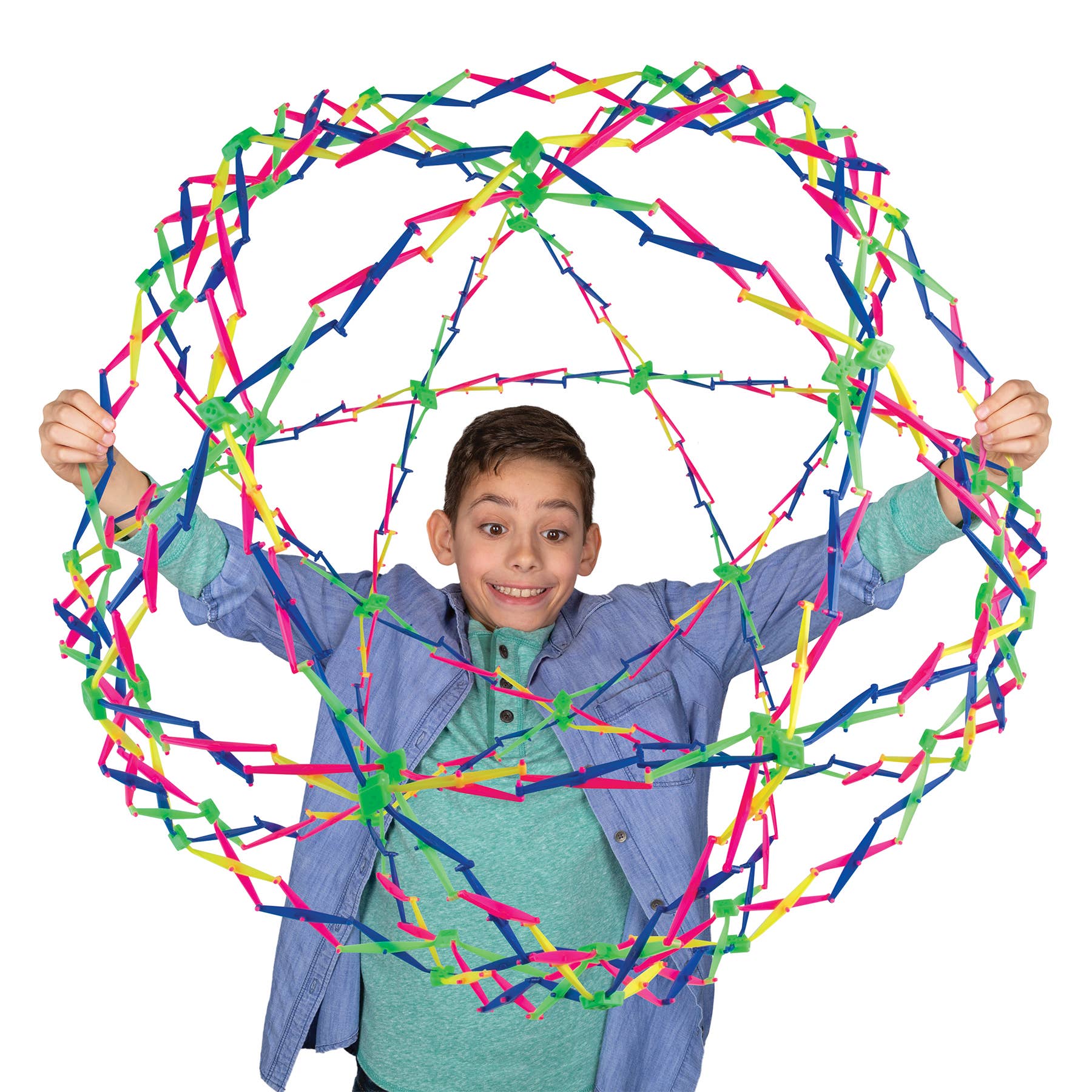 Child holding a large, colorful geometric structure made of interlocking sticks on a white background