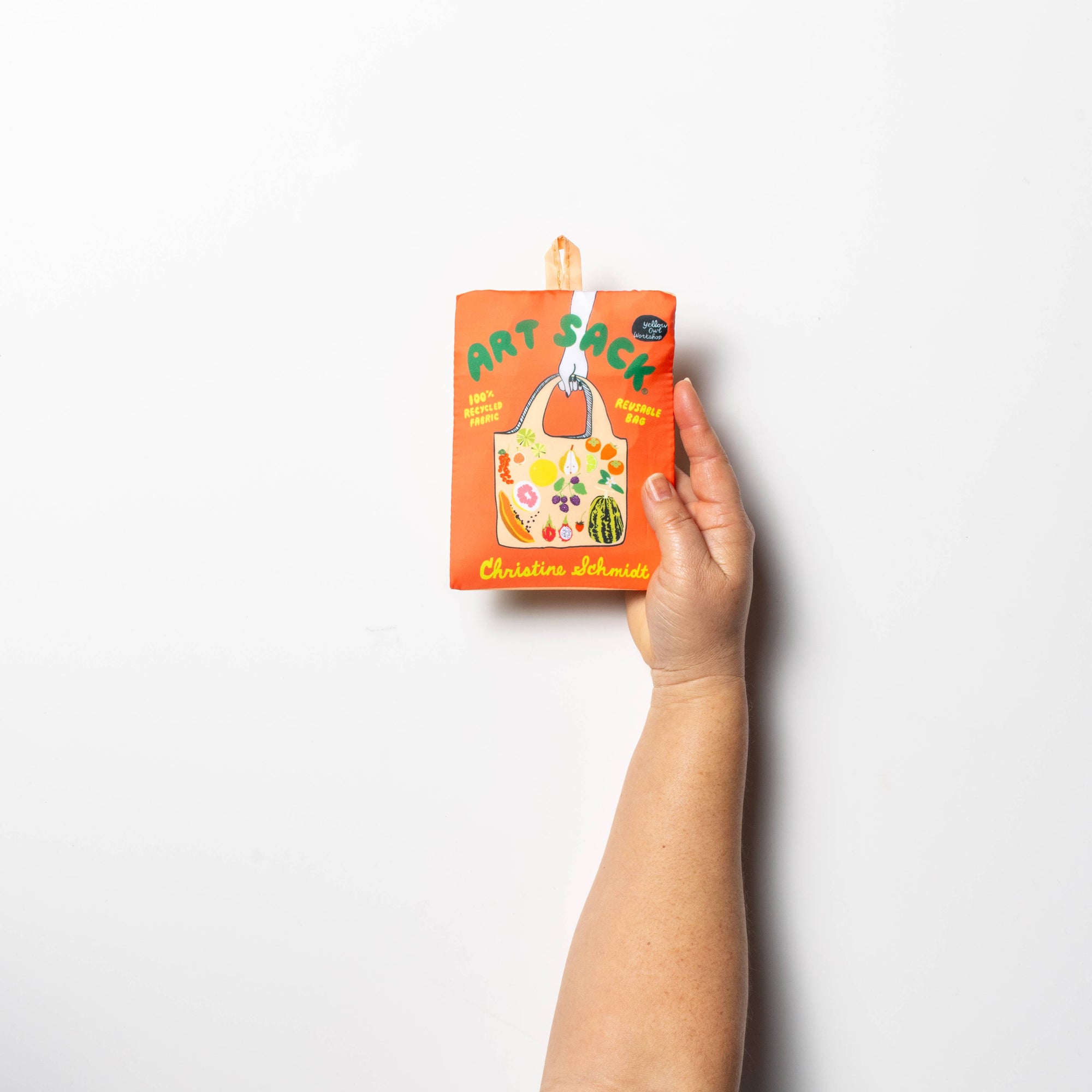 Hand holding a book titled 'Pat Sack' on a white background