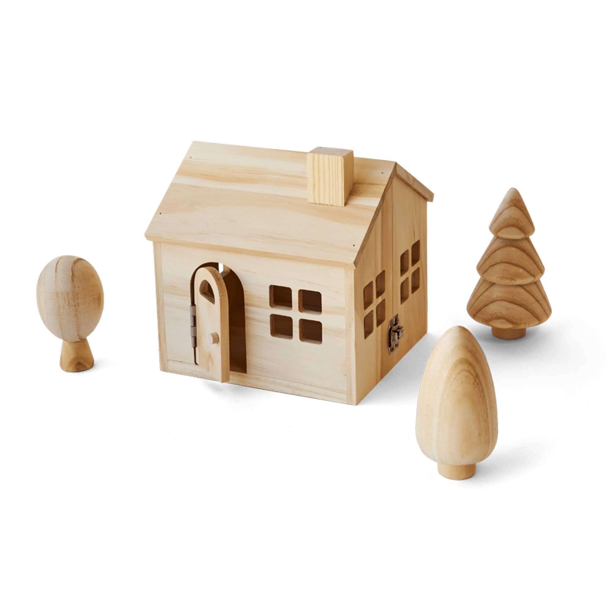 A small wooden house toy with a pitched roof, arched door, and window cutouts, shown on a white background with three matching wooden tree-like pieces around it.