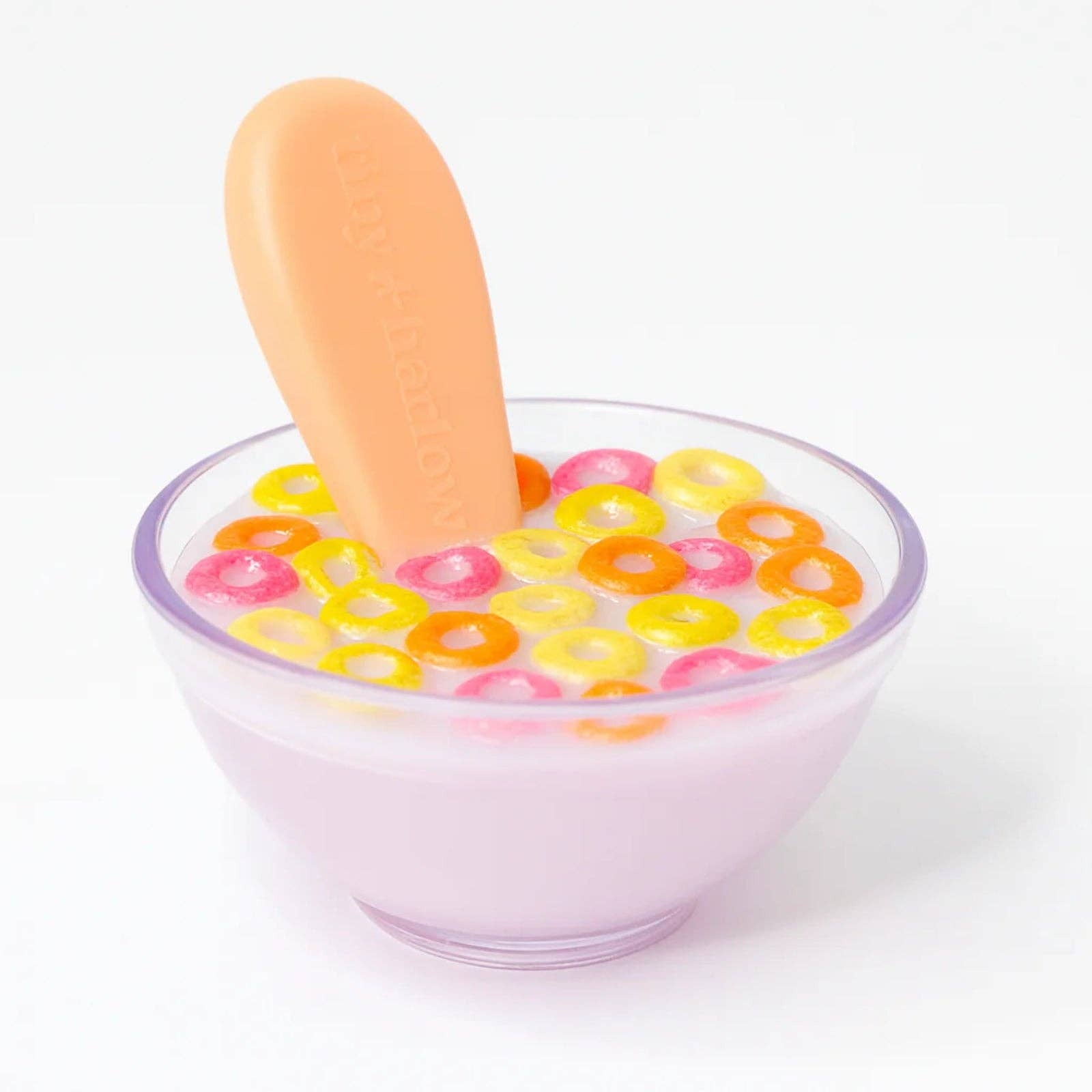 Clear bowl with colorful cereal and a spoon on a white background