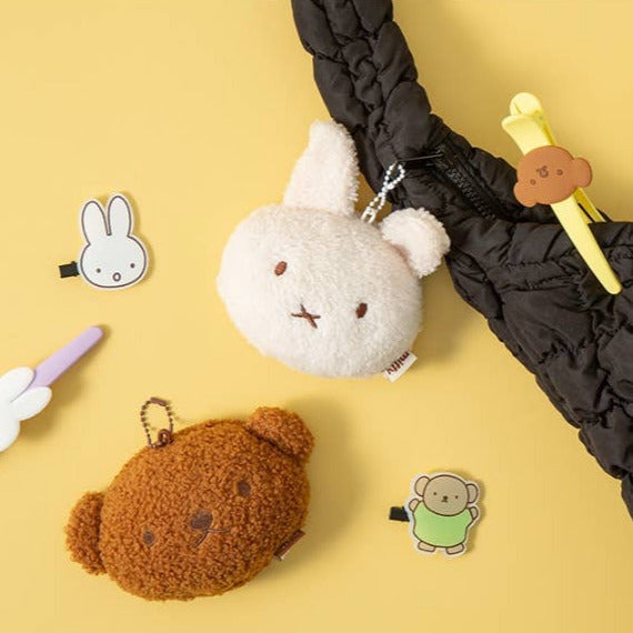 Plush keychains and stickers on a yellow background