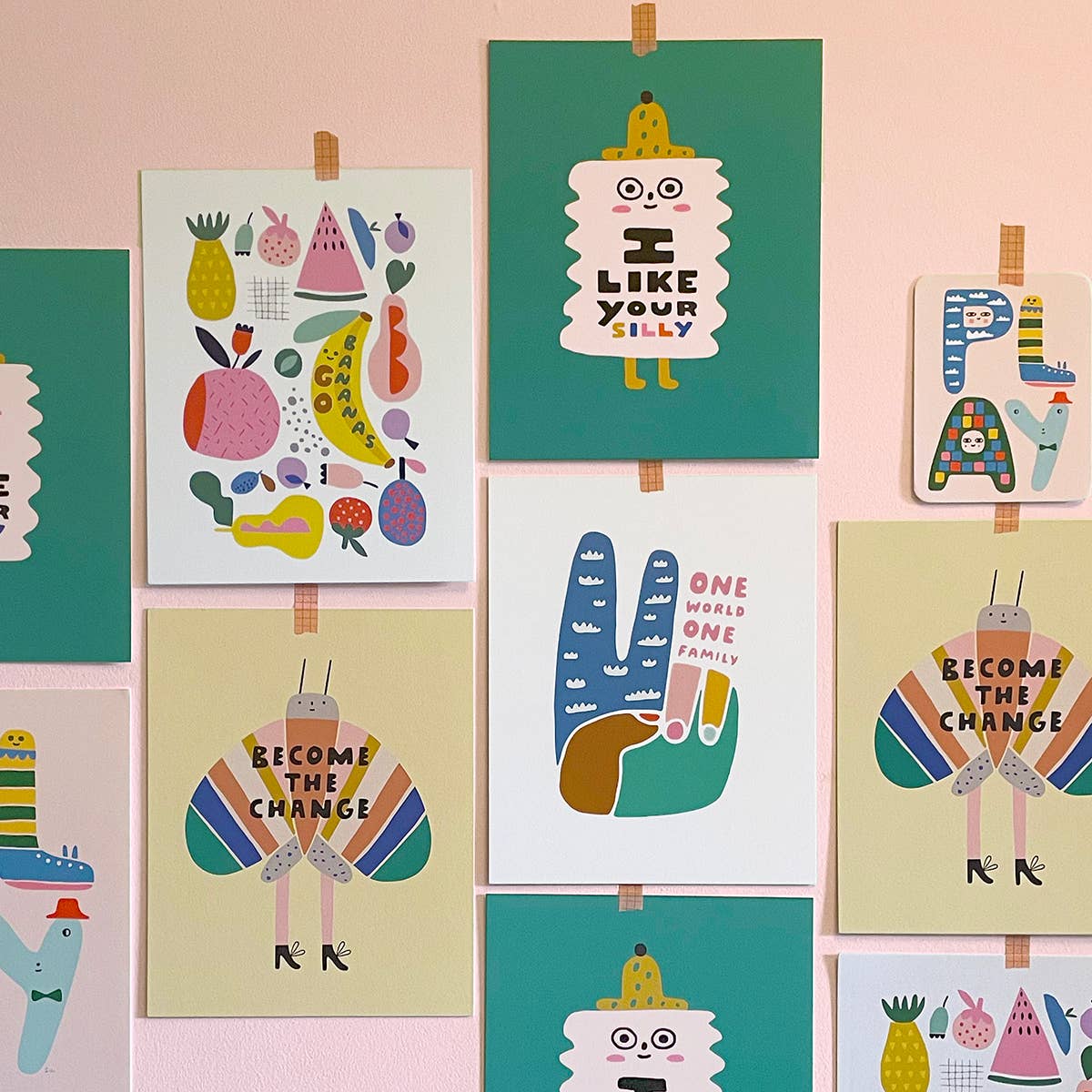 Collection of colorful children's posters on a pink wall