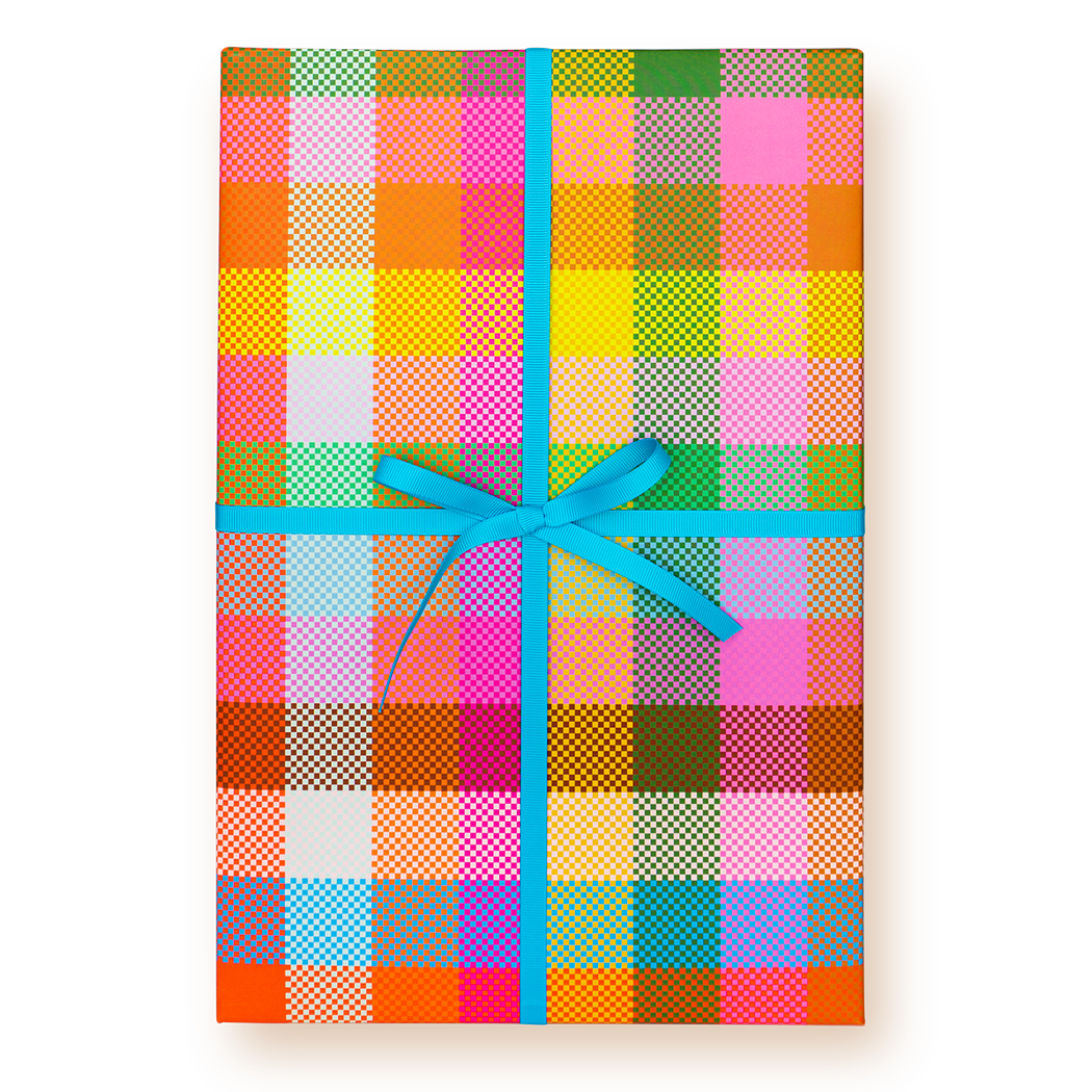 Colorful checkered gift box with a blue ribbon on a white background