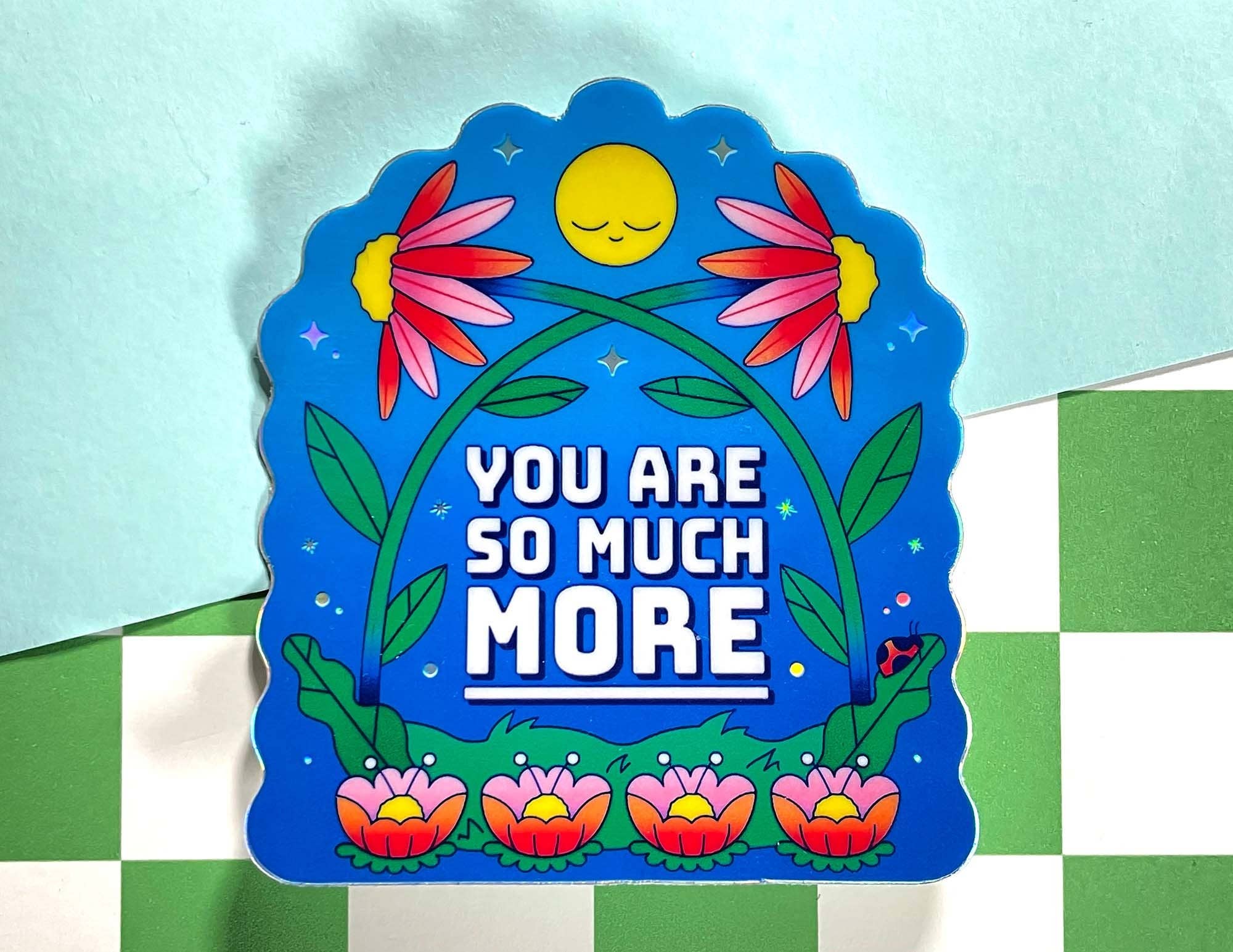 Decorative sign with flowers and text on a checkered background