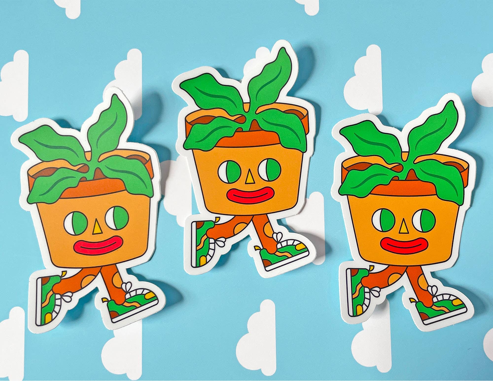 Three cartoon-style potted plants with faces on a blue background