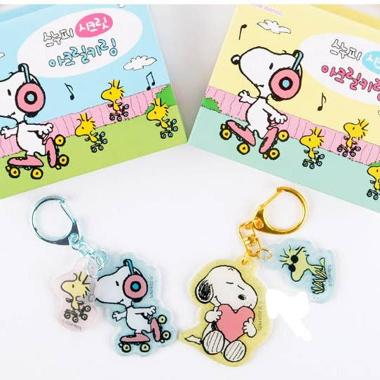 Two keychains with cartoon characters on a white background