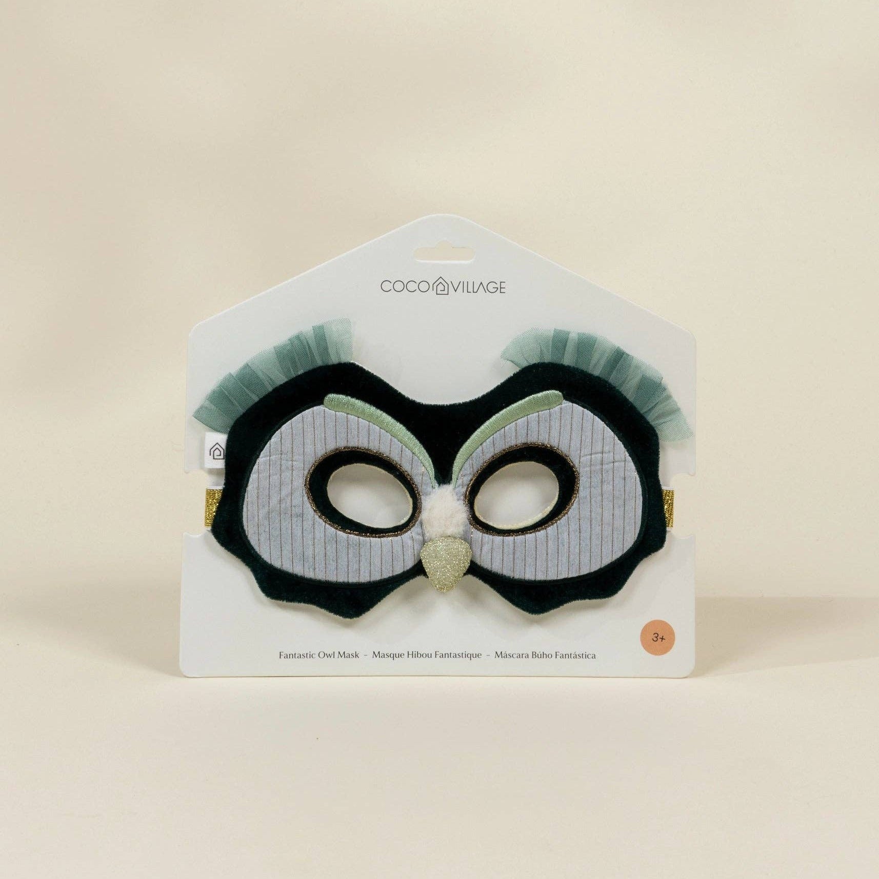 Black and white owl-themed hair clip on a beige background