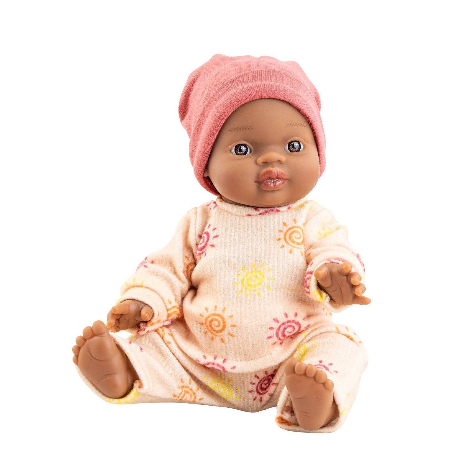 Baby doll with pink headband and patterned outfit on a white background