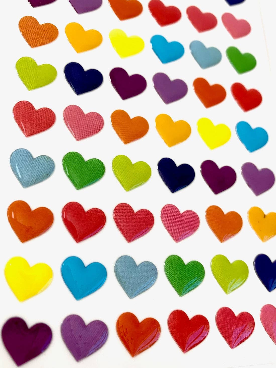 Colorful heart-shaped stickers on a white background