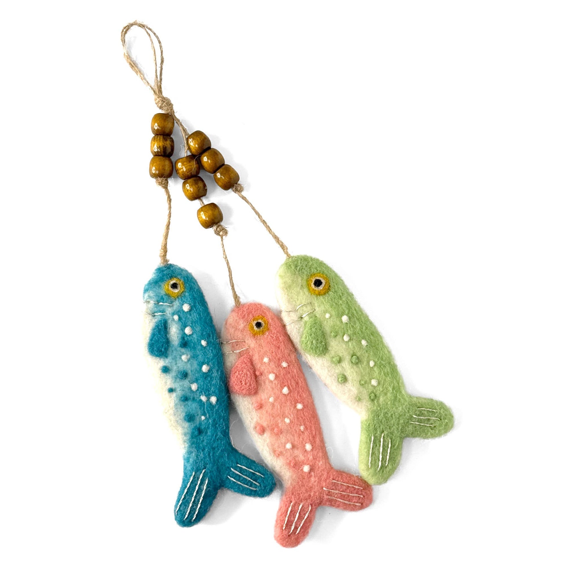 Three colorful fish-shaped felt toys hanging from wooden beads on a white background
