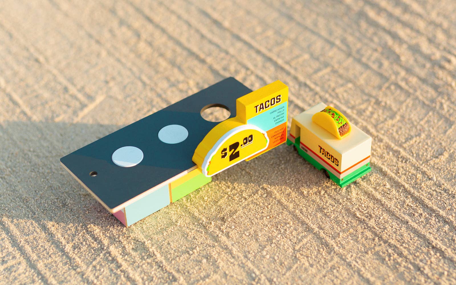 Toy taco stand with a toy car on a textured surface