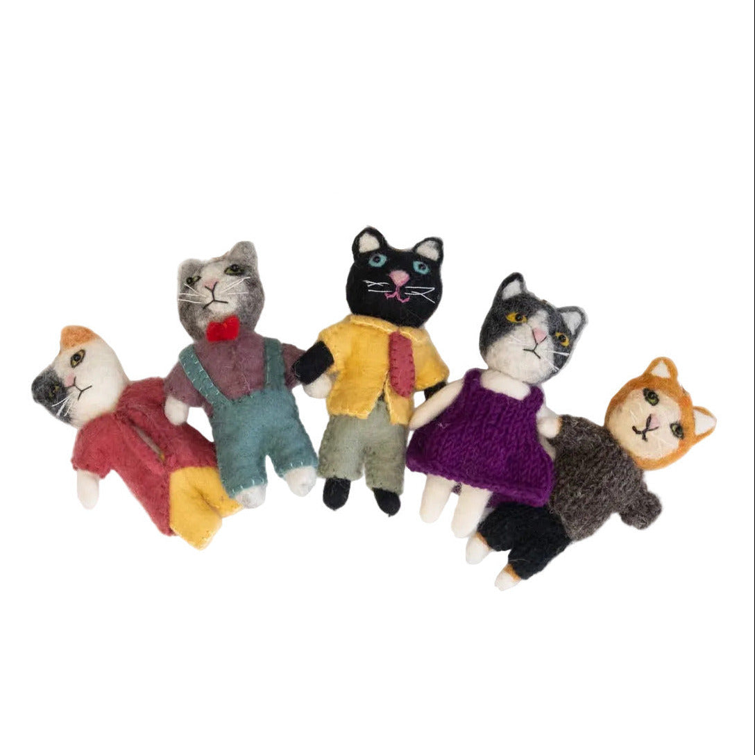 Set of felt cat ornaments with colorful clothing on a white background