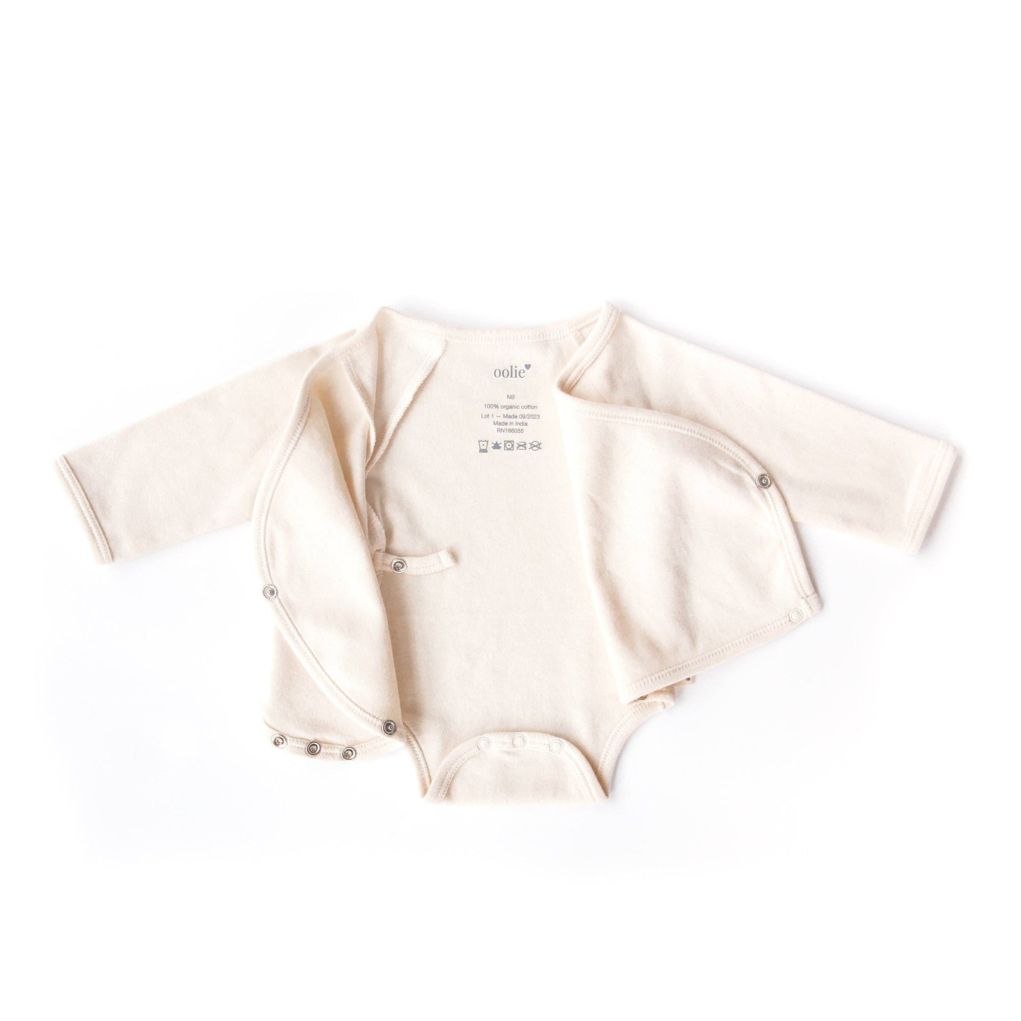 Beige baby onesie with long sleeves on a white background